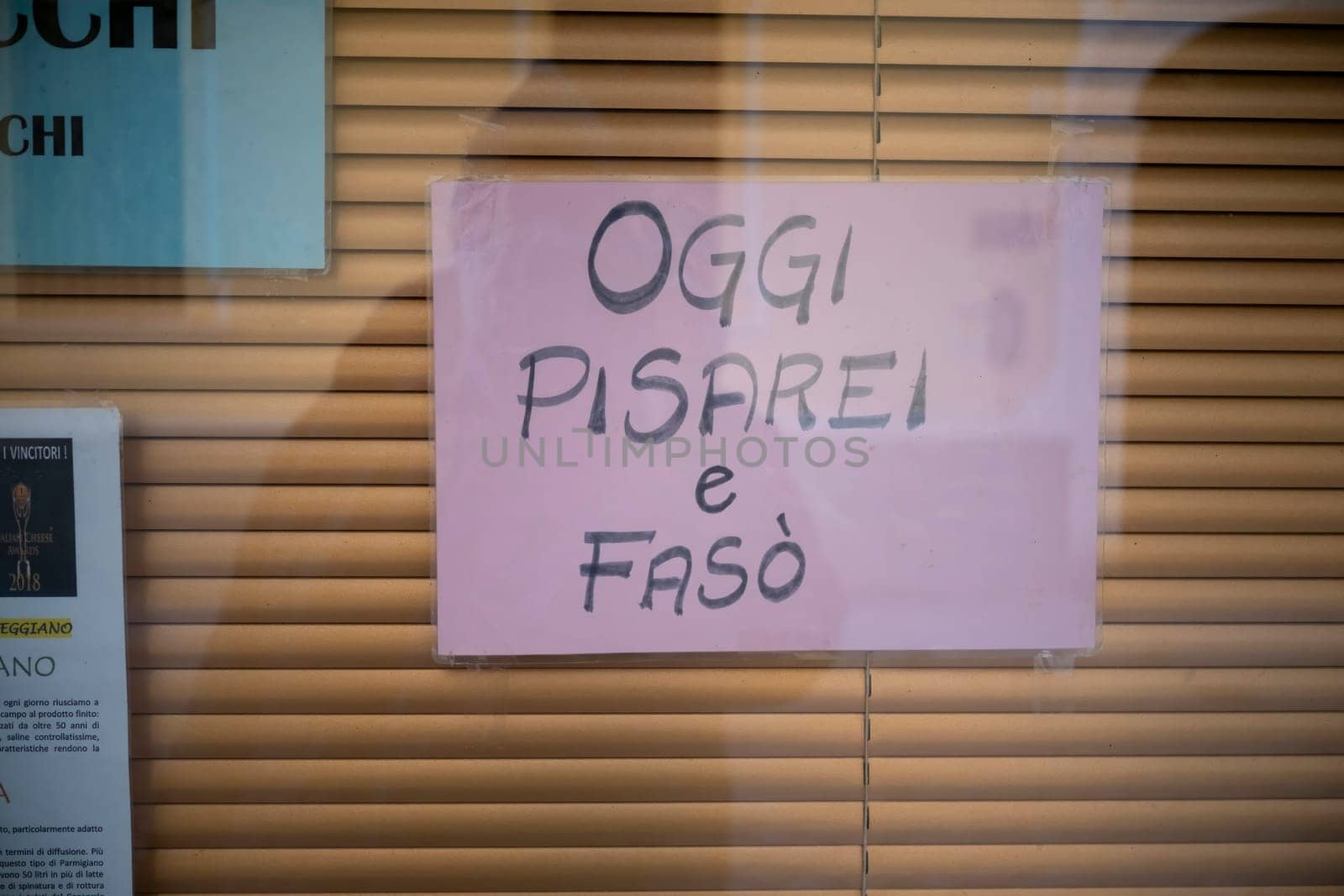 Cremona, Italy - November 27th 2024 Pink sign on a restaurant window in cremona, italy, announcing oggi pisarei e fasò, indicating the availability of this local dish