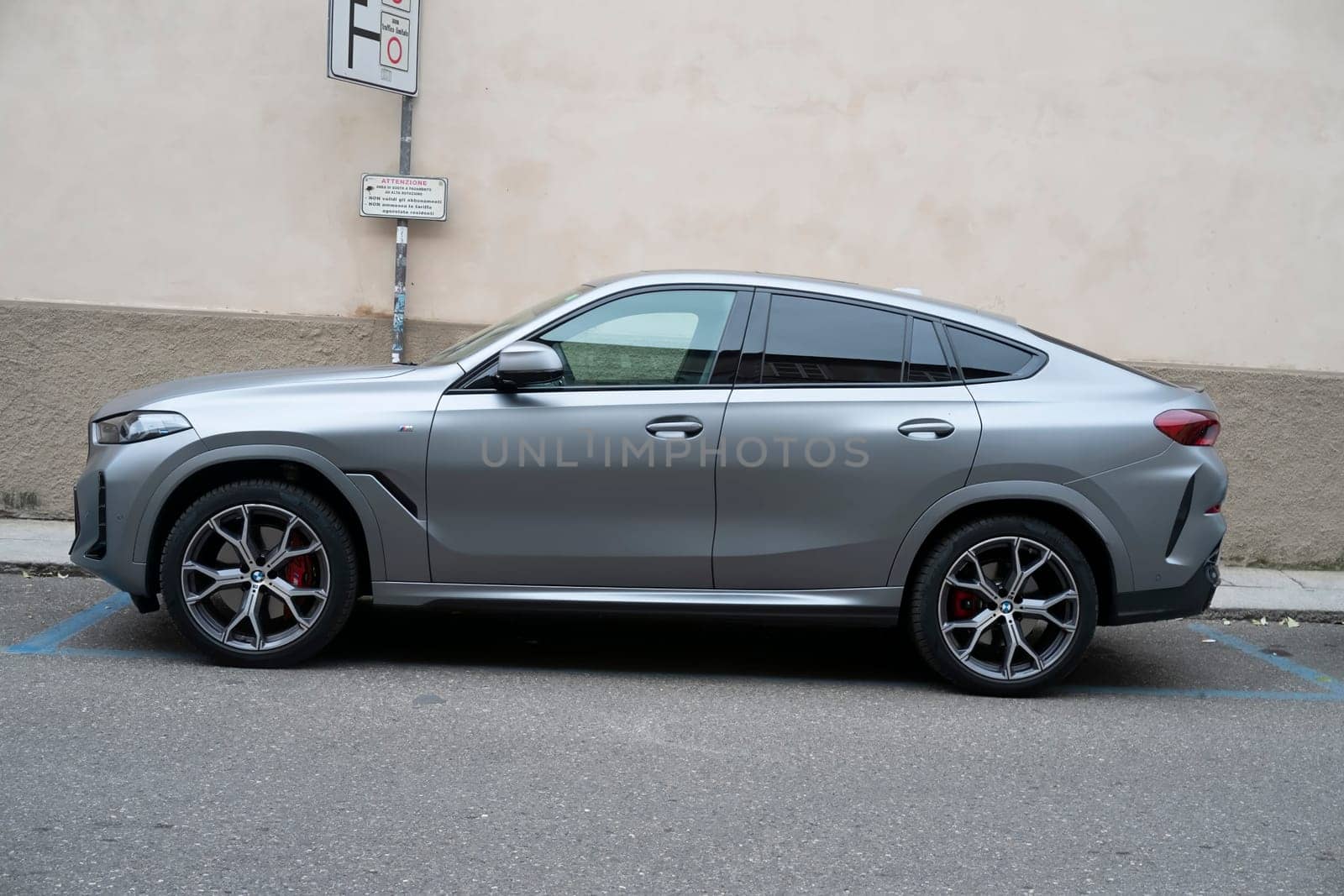 Cremona, Lombardy, Italy - October 27th 2024 Parked bmw x6 m competition in brooklyn grey metallic color, highlighting its sporty and luxurious design