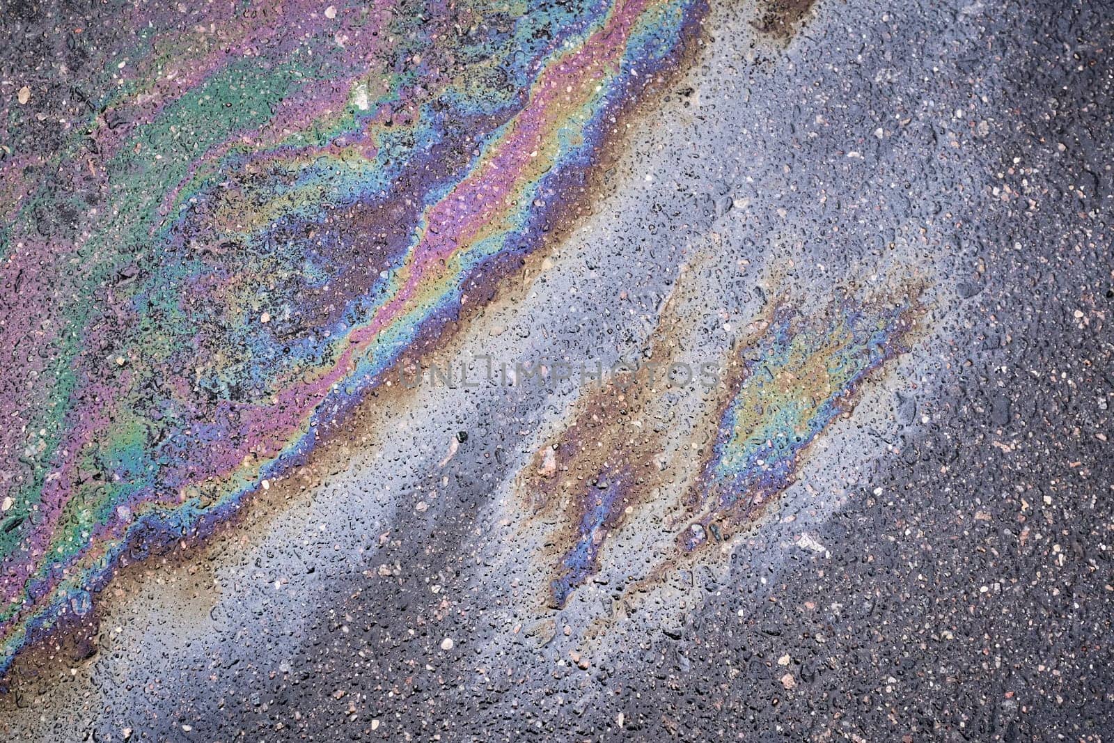 Bright stain from oil or gasoline on asphalt