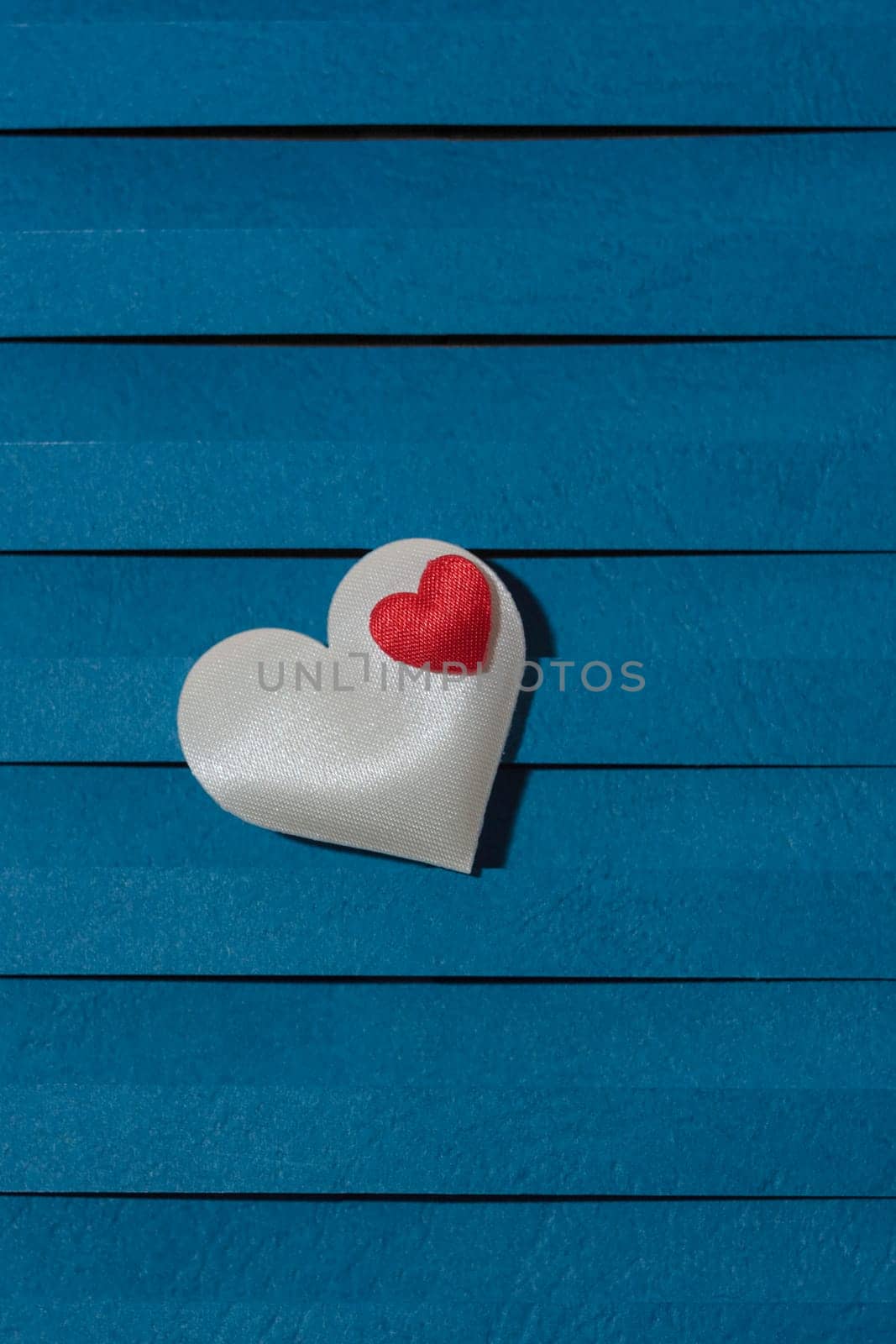 Loving fabric hearts on a blue background, perfect for Valentine's Day.