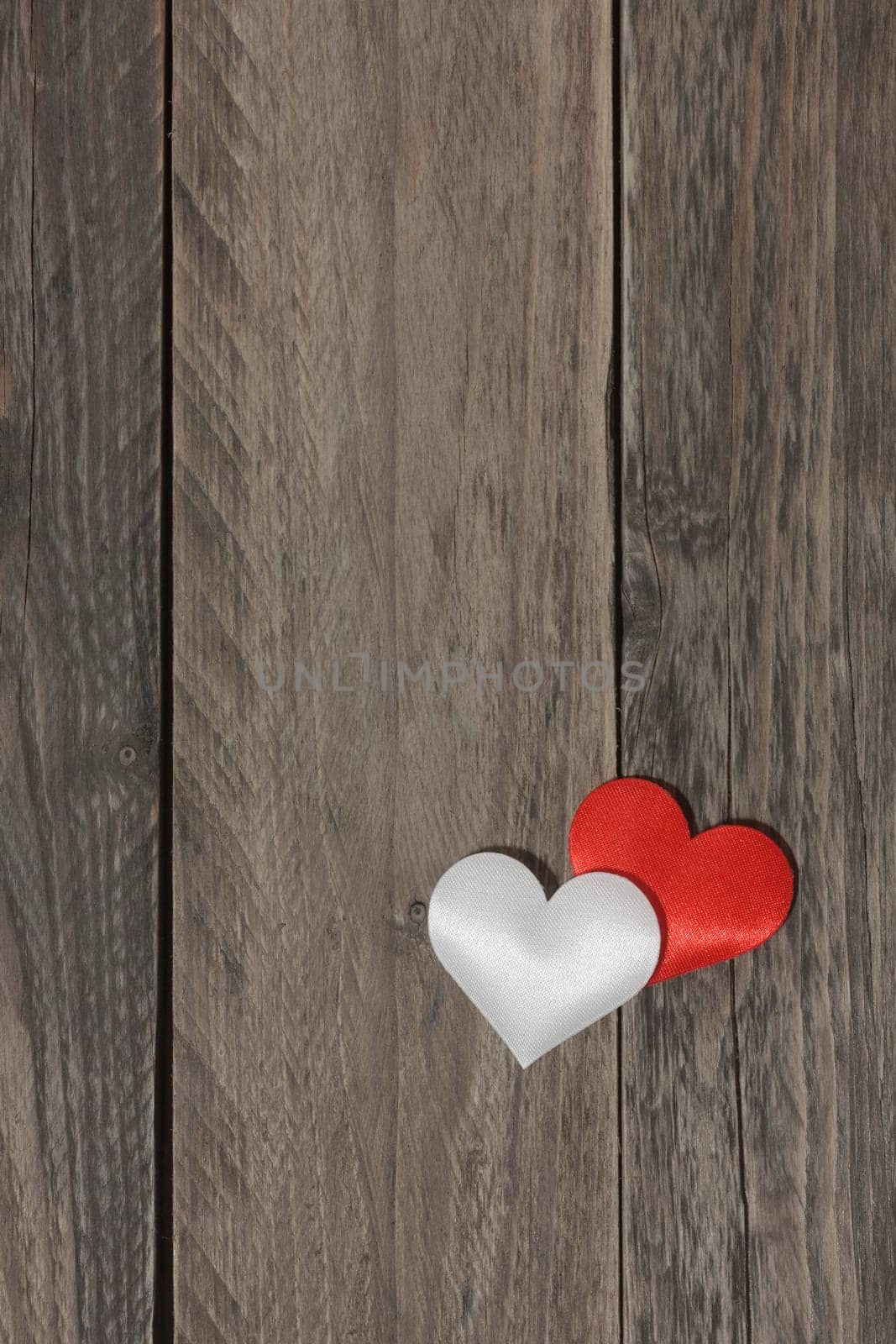 Love concept. Two hearts on a wood background