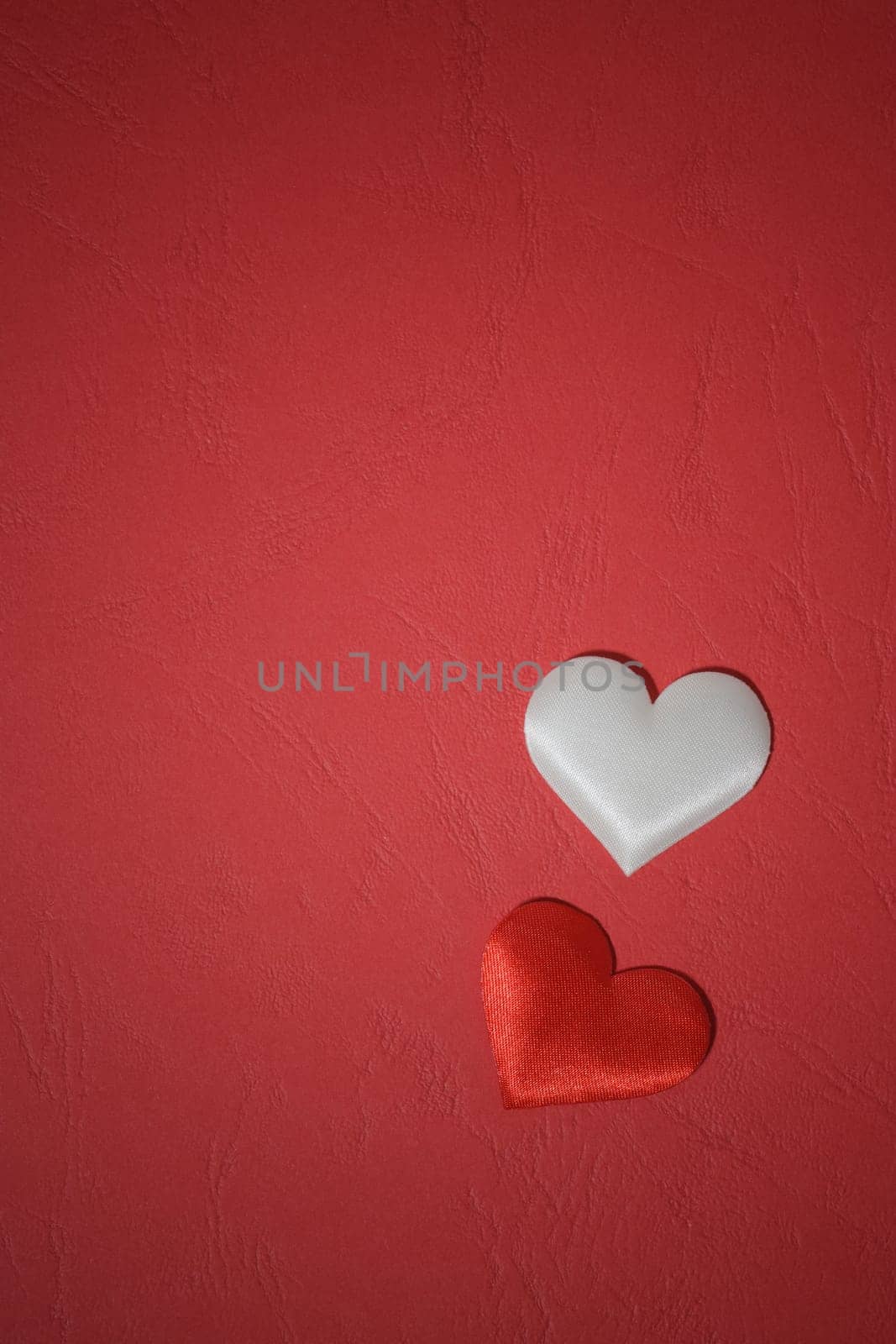 Love concept. Two hearts on a red background