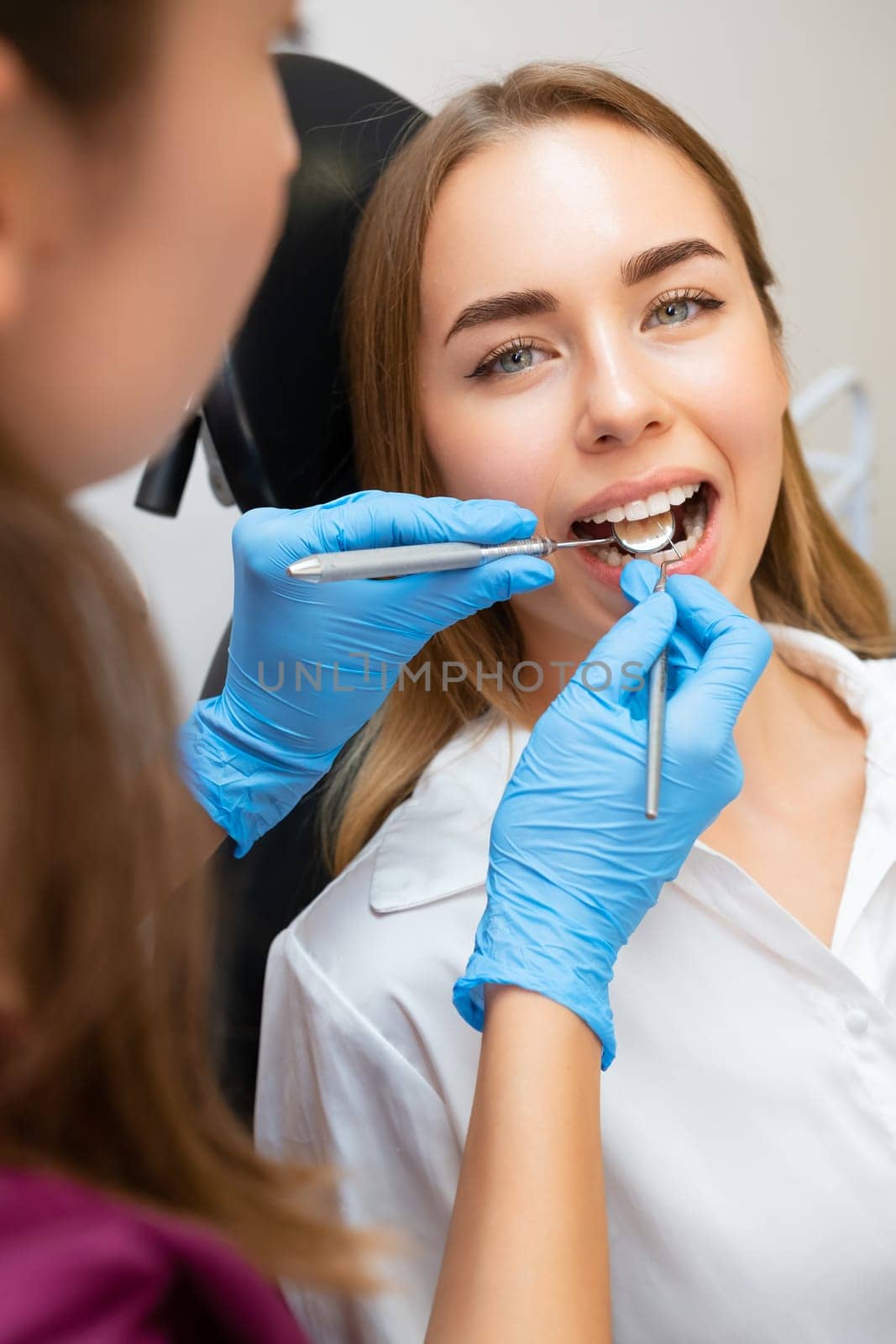 Female Patient in Dental Chair for Treatment by vladimka