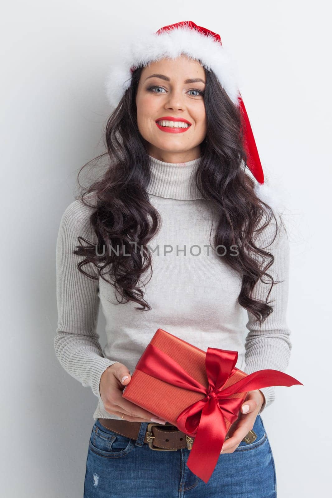 Beautiful woman in Santa Claus hat with gift box