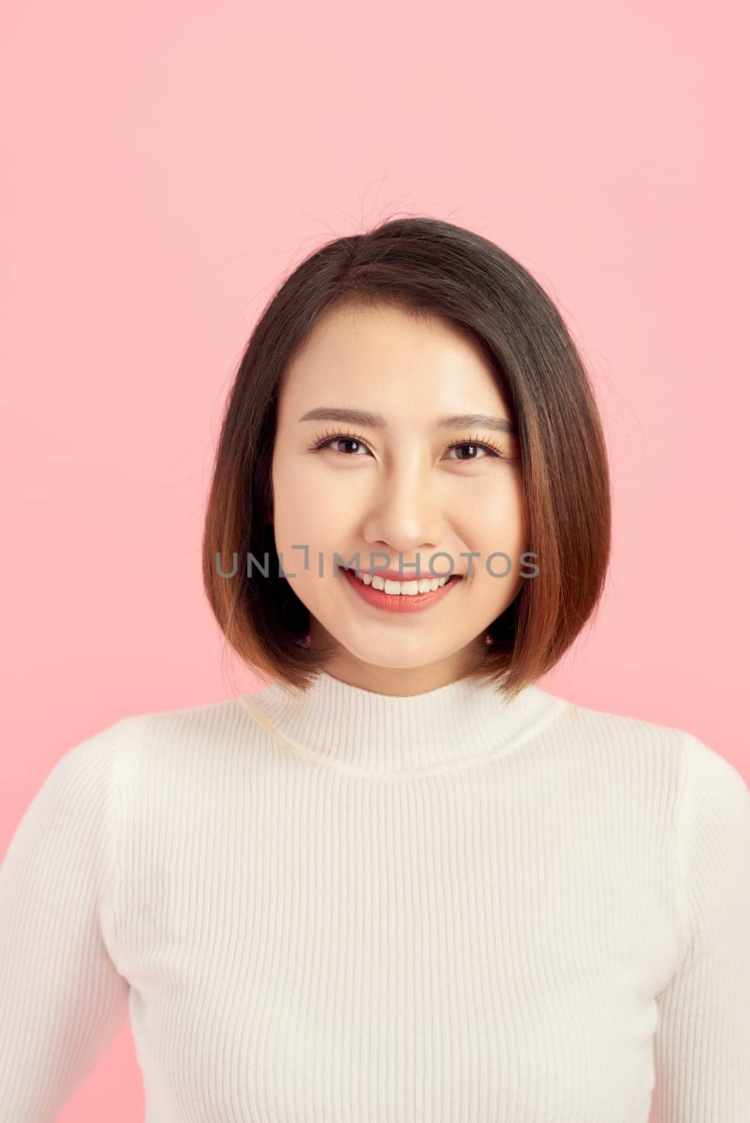 Portrait of young confident Asian woman on pink background. by makidotvn