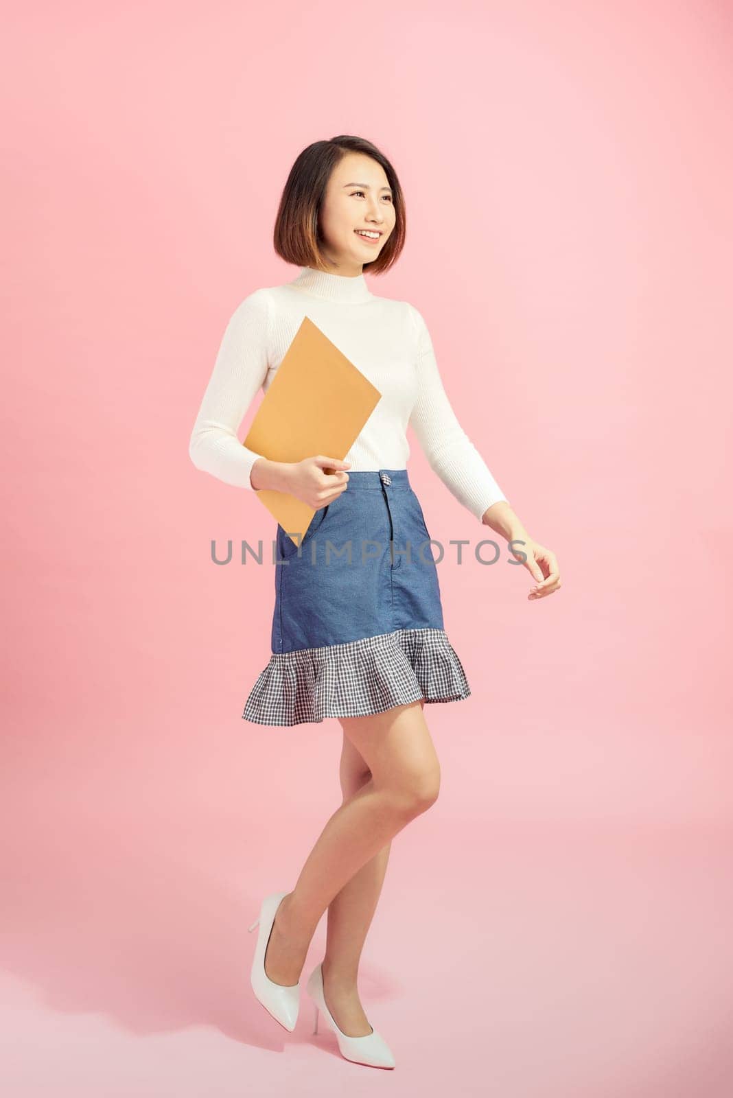 Young Asian woman holding the file standing on the white background.