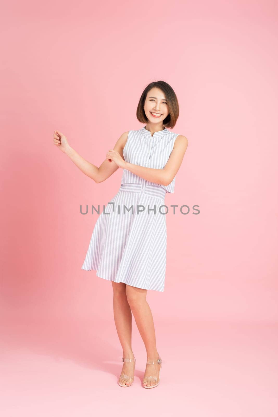 Confident girl laughing at camera. Studio shot of elegant white woman isolated on yellow background. by makidotvn