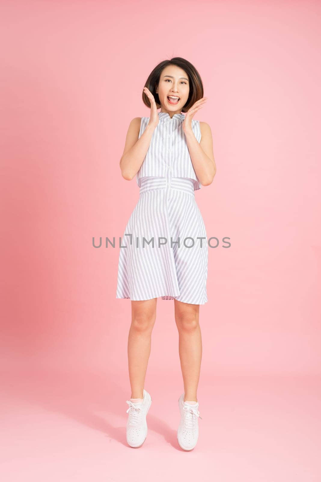 Vertical full length body size studio photo portrait of cute cool free fresh charming pretty attractive lady in light blue clothing feeling expressing happiness isolated bright pastel soft background by makidotvn