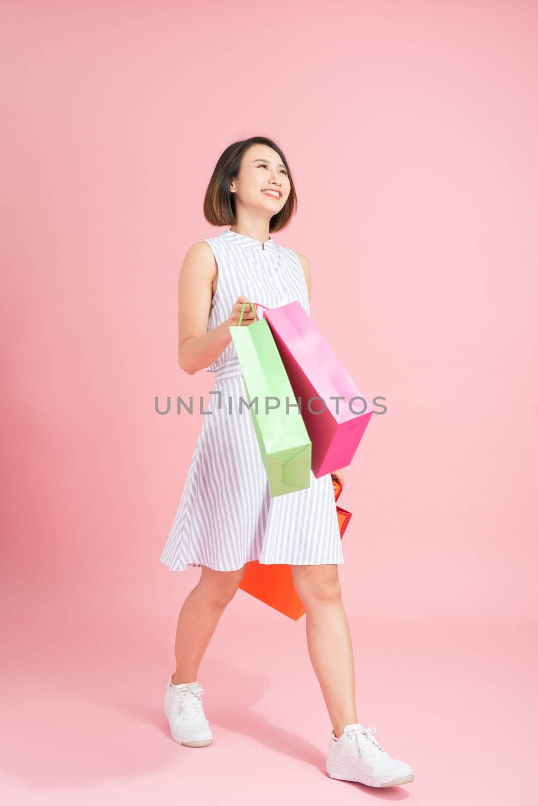 Excited female shopaholic with shopping bags