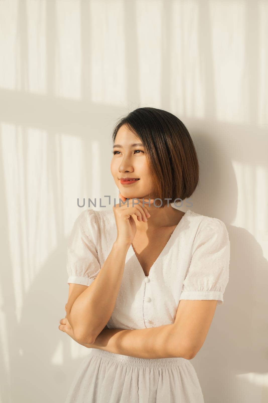 Beautiful young Asian woman sunlight and light clothes