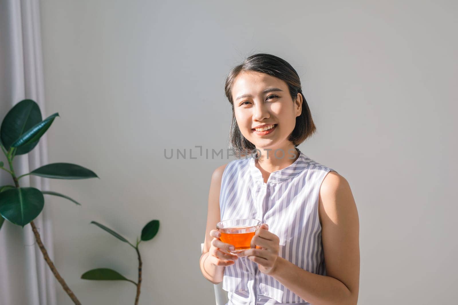 Young asian girl feeling happy with her cup by makidotvn