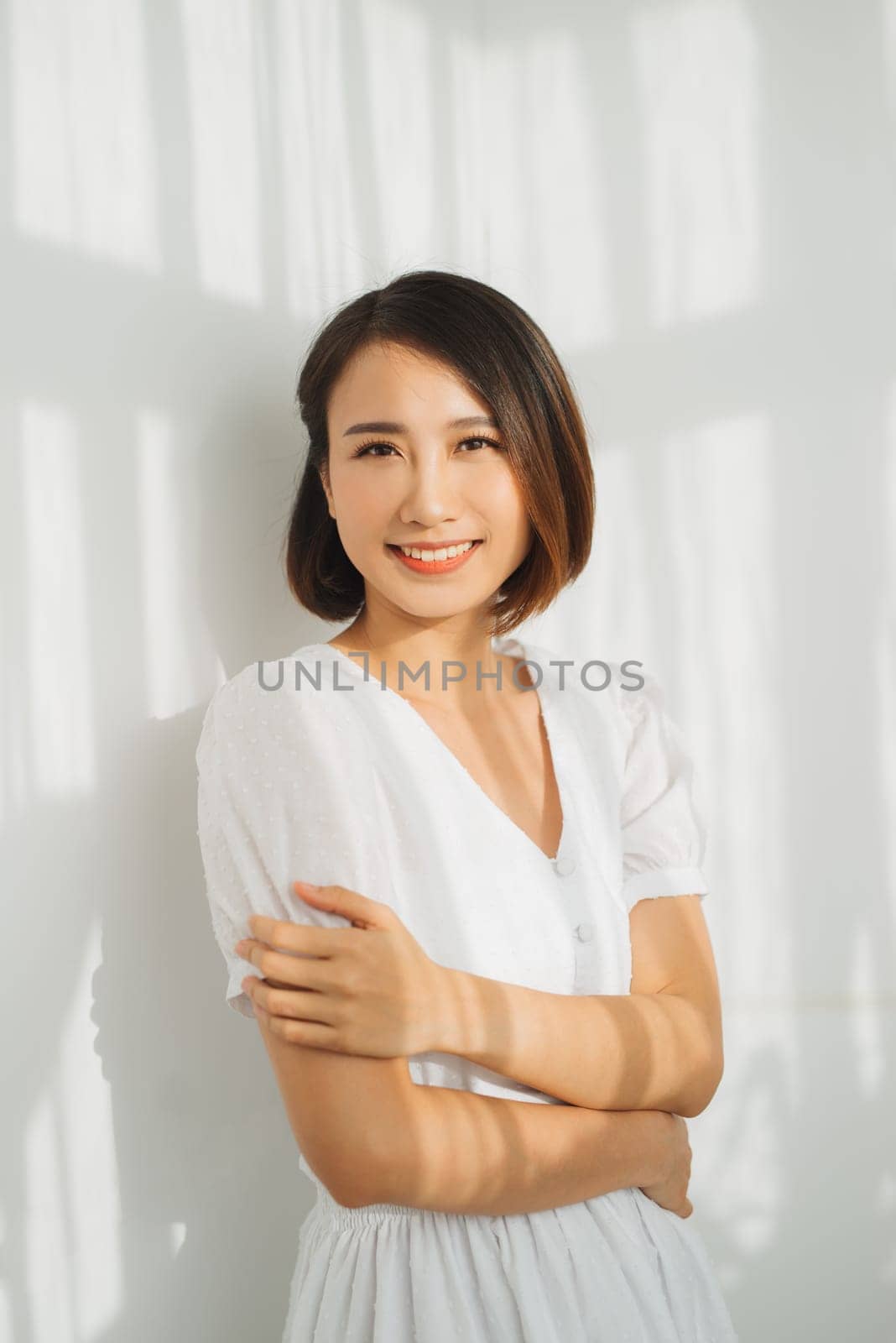 Closeup portrait of sexy woman with shadow falling face and white wall by makidotvn