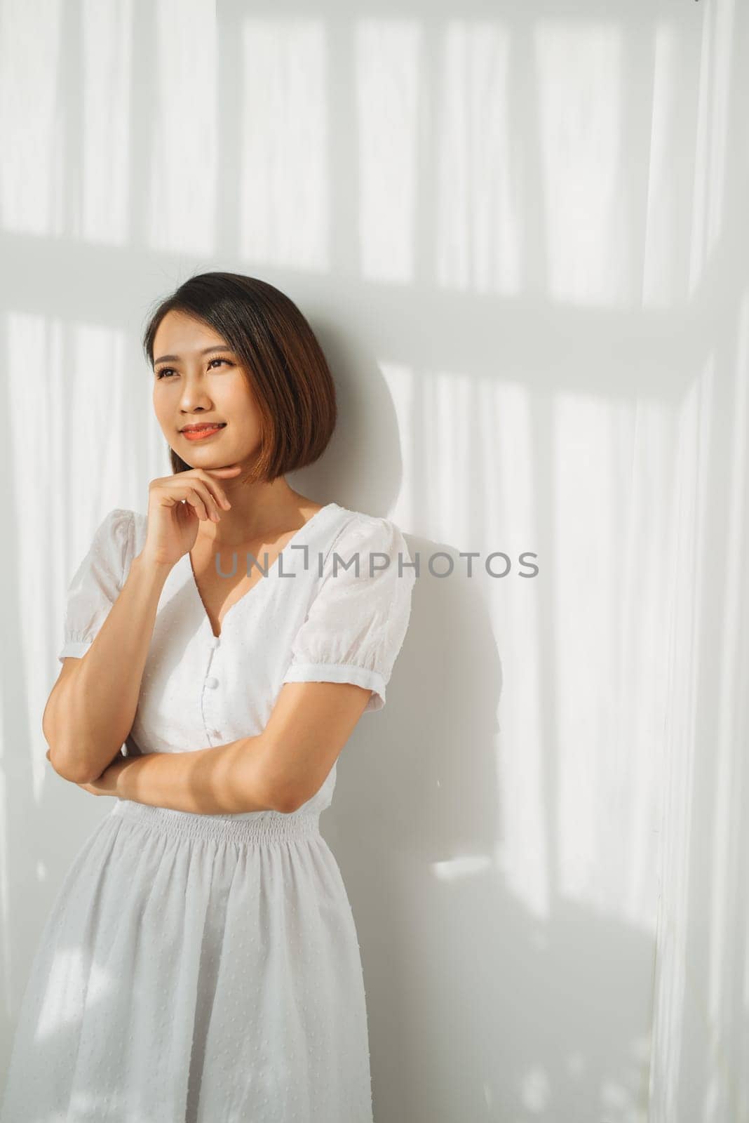 Closeup portrait of sexy woman with shadow falling face and white wall
