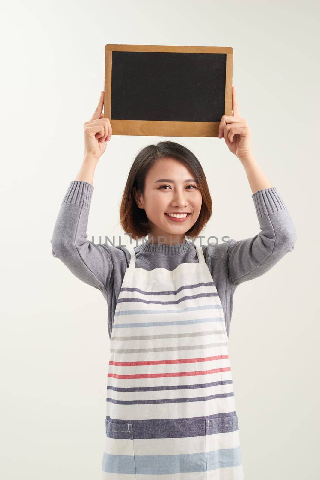 Asian woman wearing apron on white isolated background