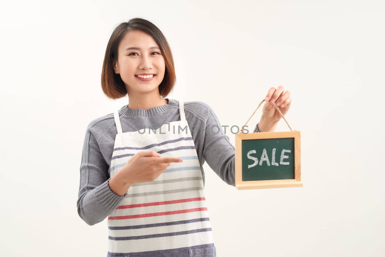 Woman finger point to chalkboard and showing sale word