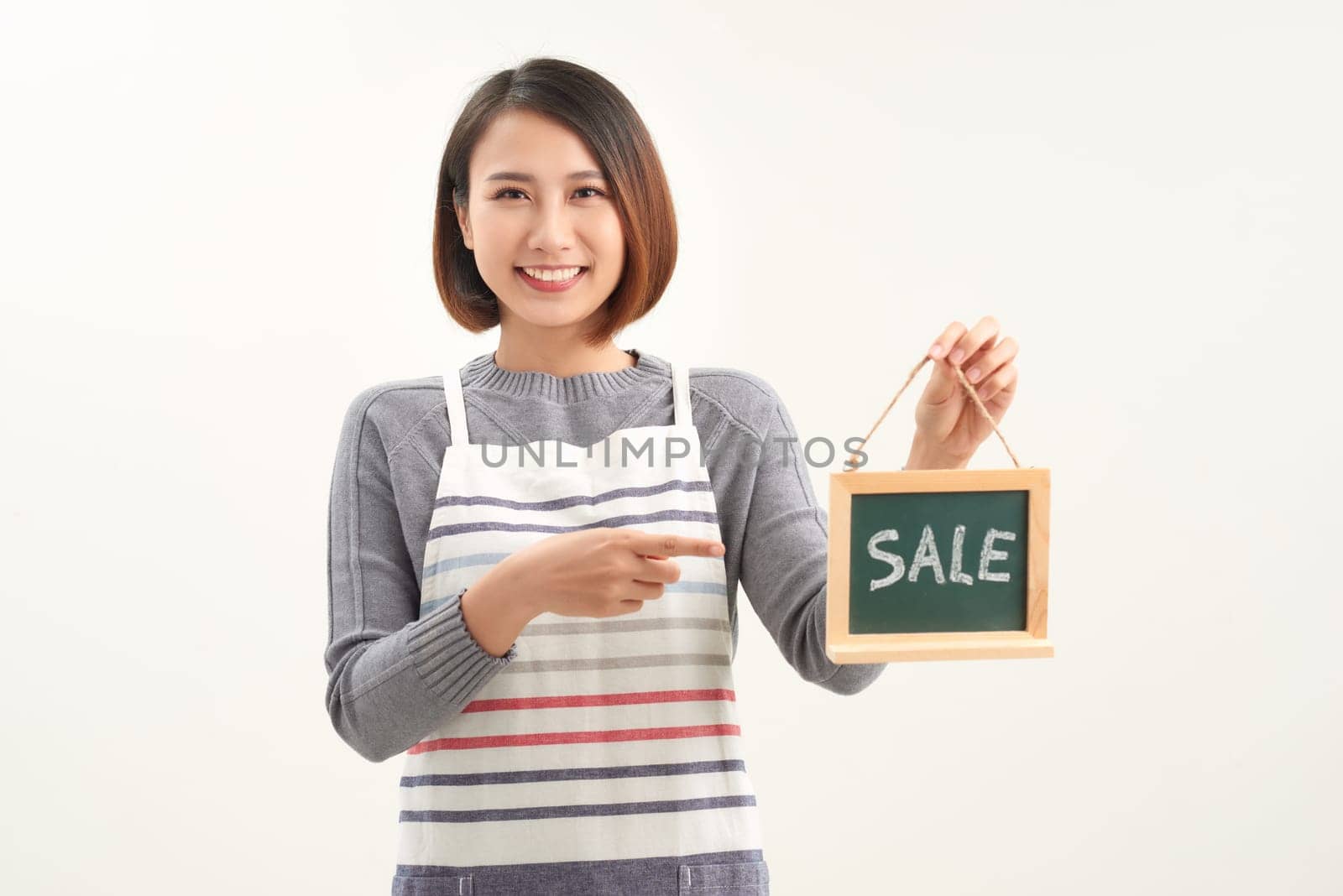 Female waitress holds sign board with sale word. Advertising banner by makidotvn