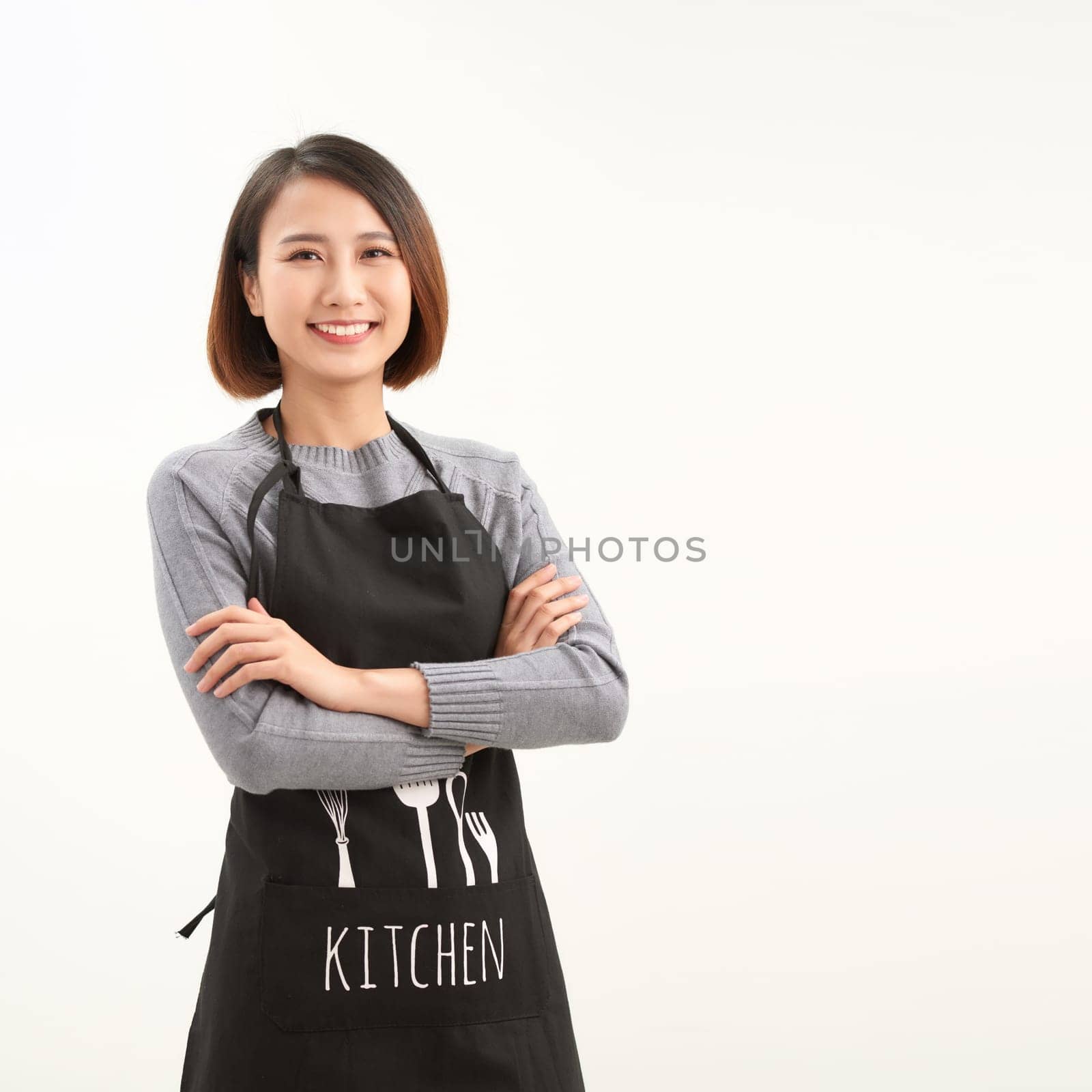 Waitress with black apron and crossed arms