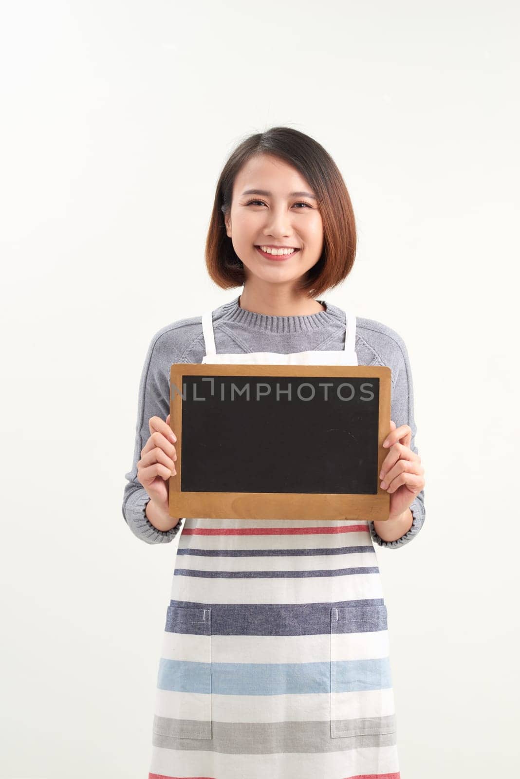 happy small business owner ready to open her cafe for the first time. holding white board by makidotvn