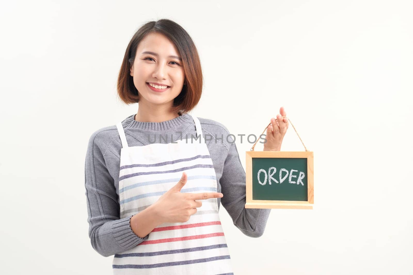 Portrait of waitress showing chalkboard with order sign on white