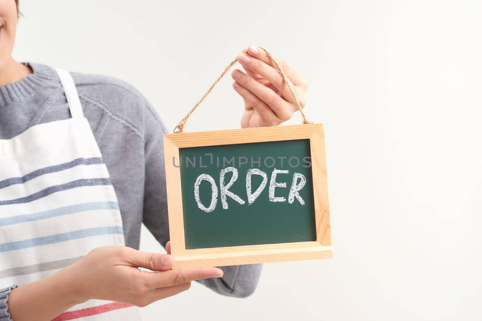 Waitress holding the chalkboard order sign on white background