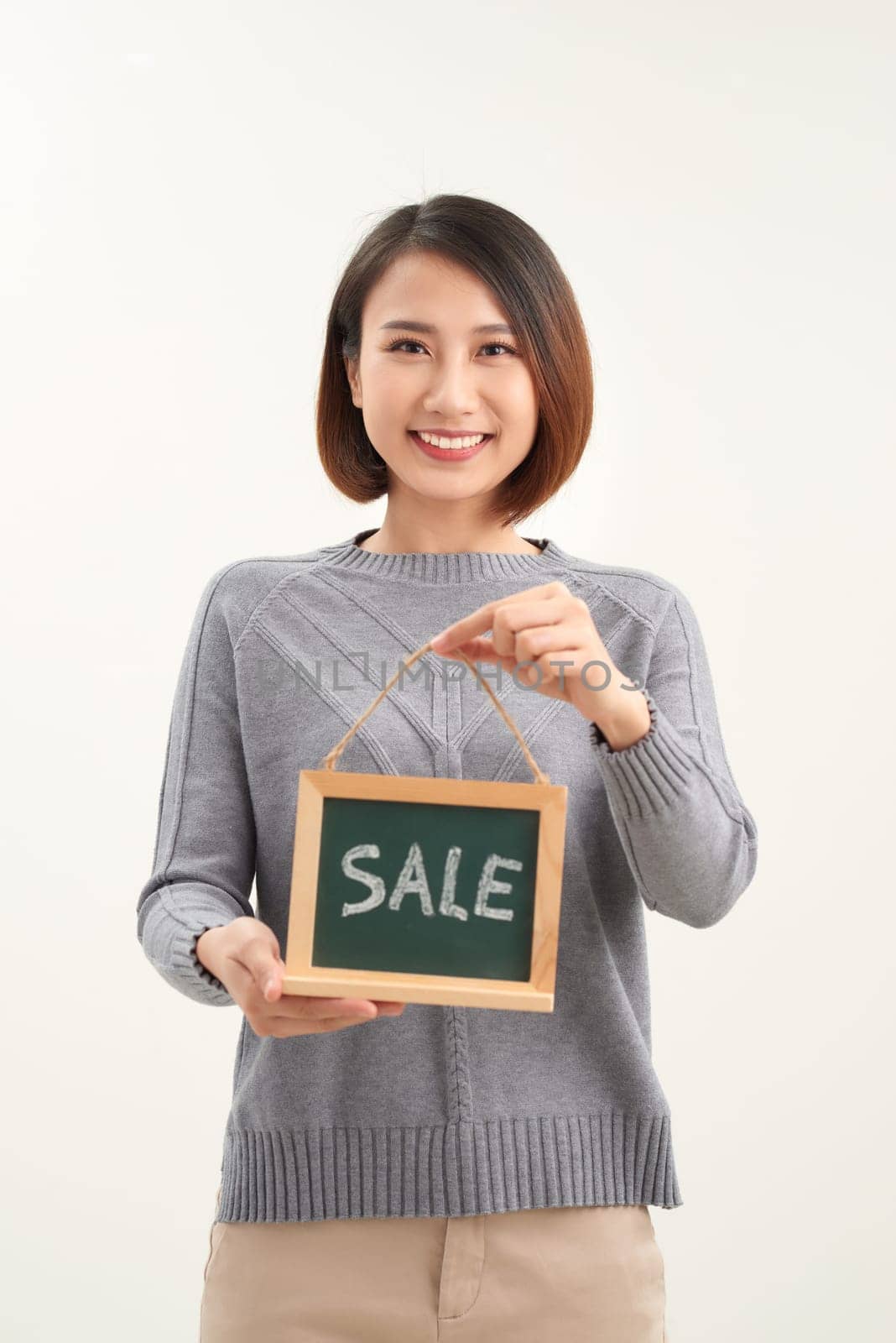 excited happy beautiful young woman with sale sign isolated over white by makidotvn