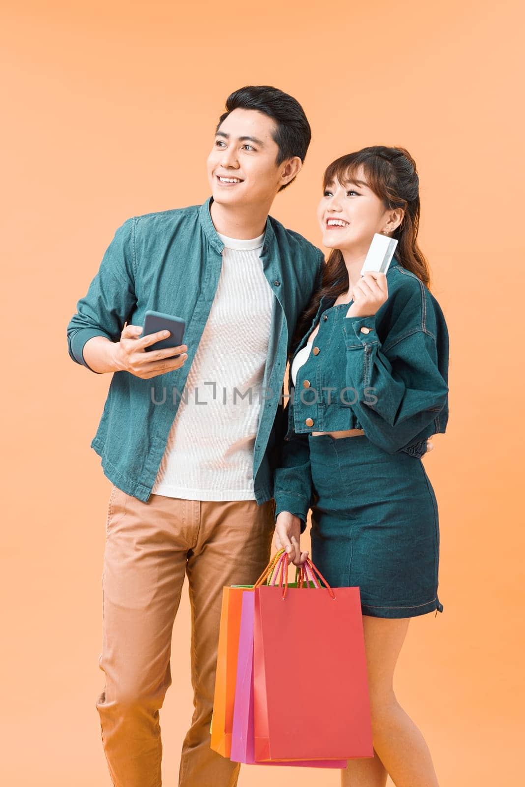 Young cute couple is excited about online shopping with credit card by makidotvn