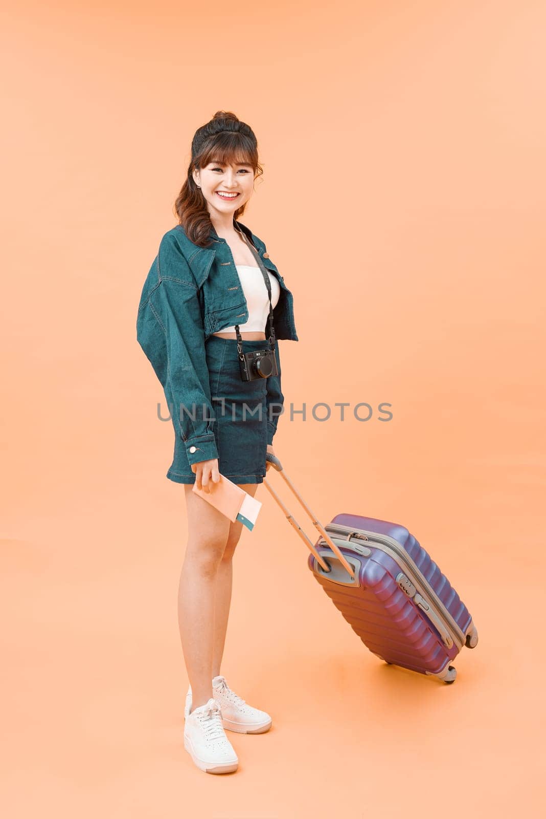 Young travelling woman isolated on color background