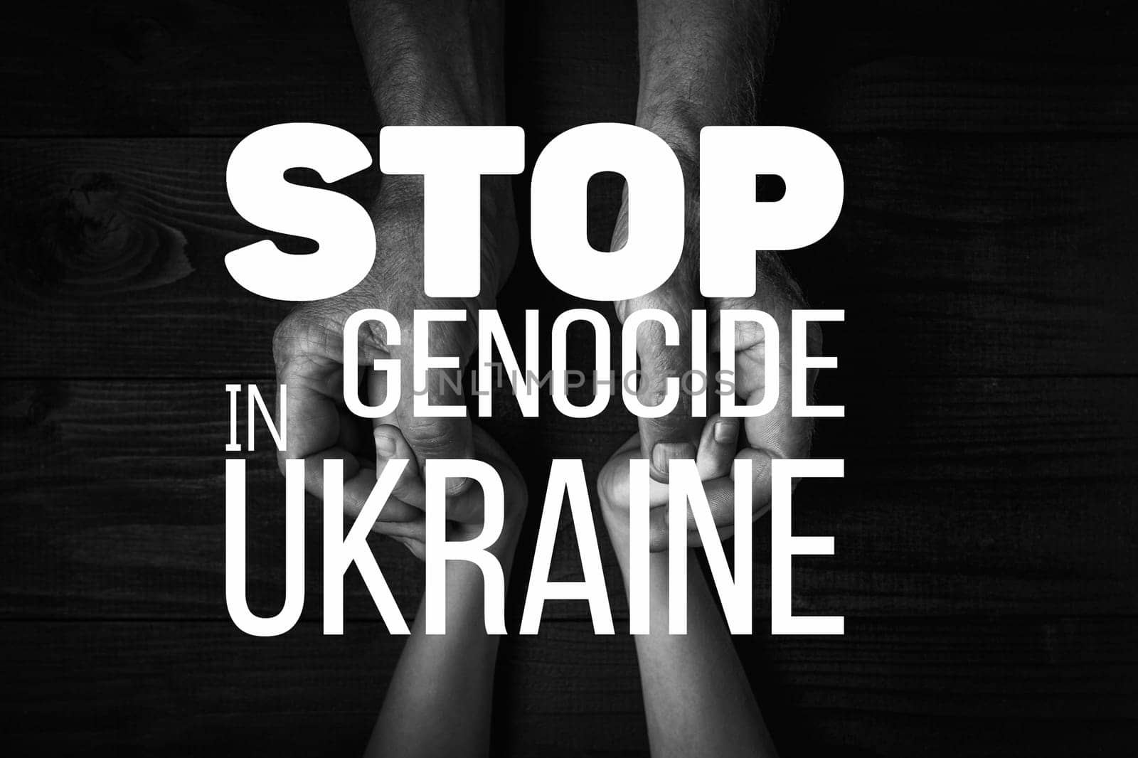 words stop genocide in ukraine against the background of childrens hands holding each other. black and white color. concept needs help and support, truth will win