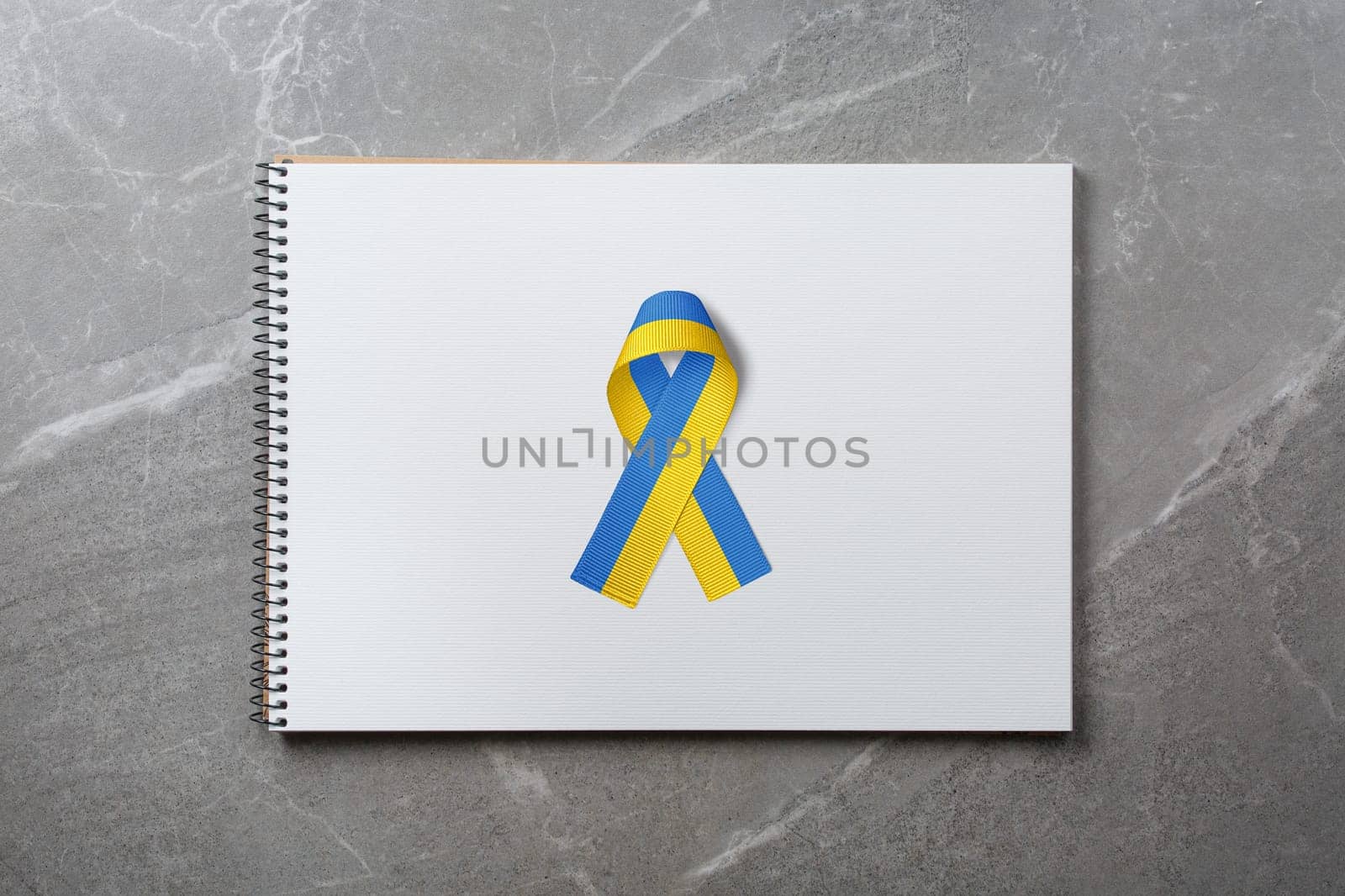 yellow and blue ribbon on notepad by alexxndr