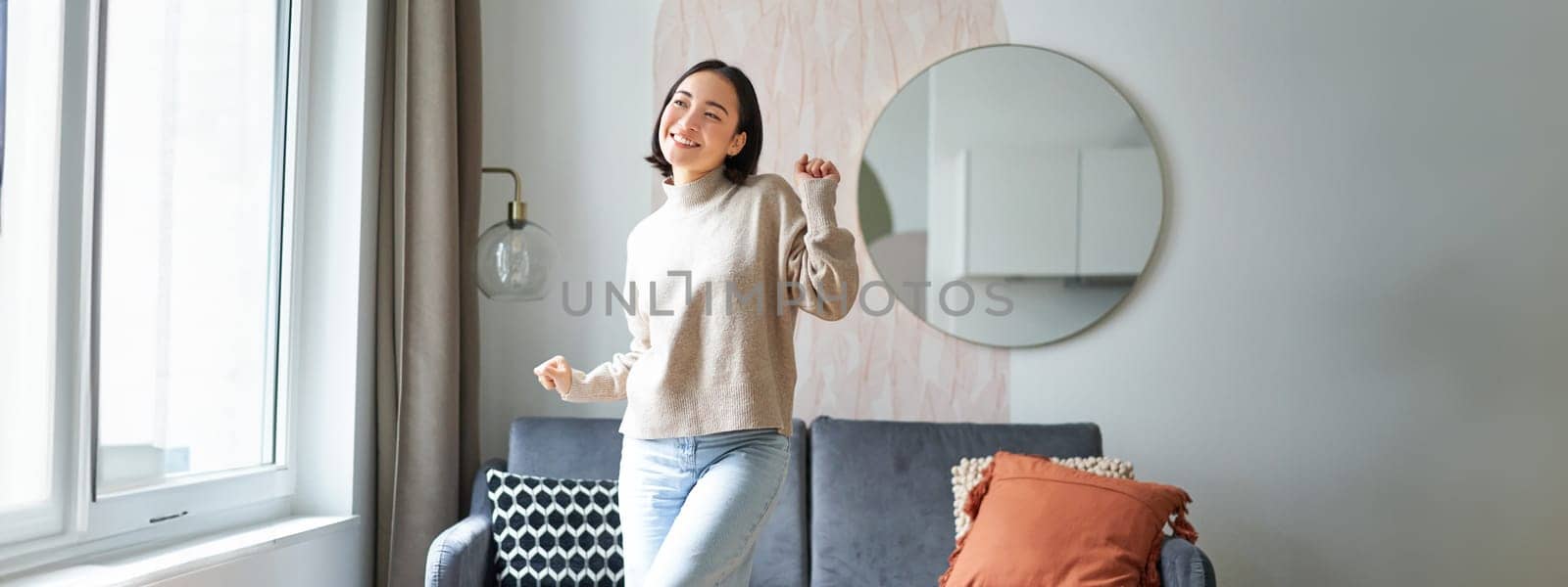 People and emotions. Joyful teen girl dancing in her room, feeling happy and carefree, concept of joy and satisfaction by Benzoix