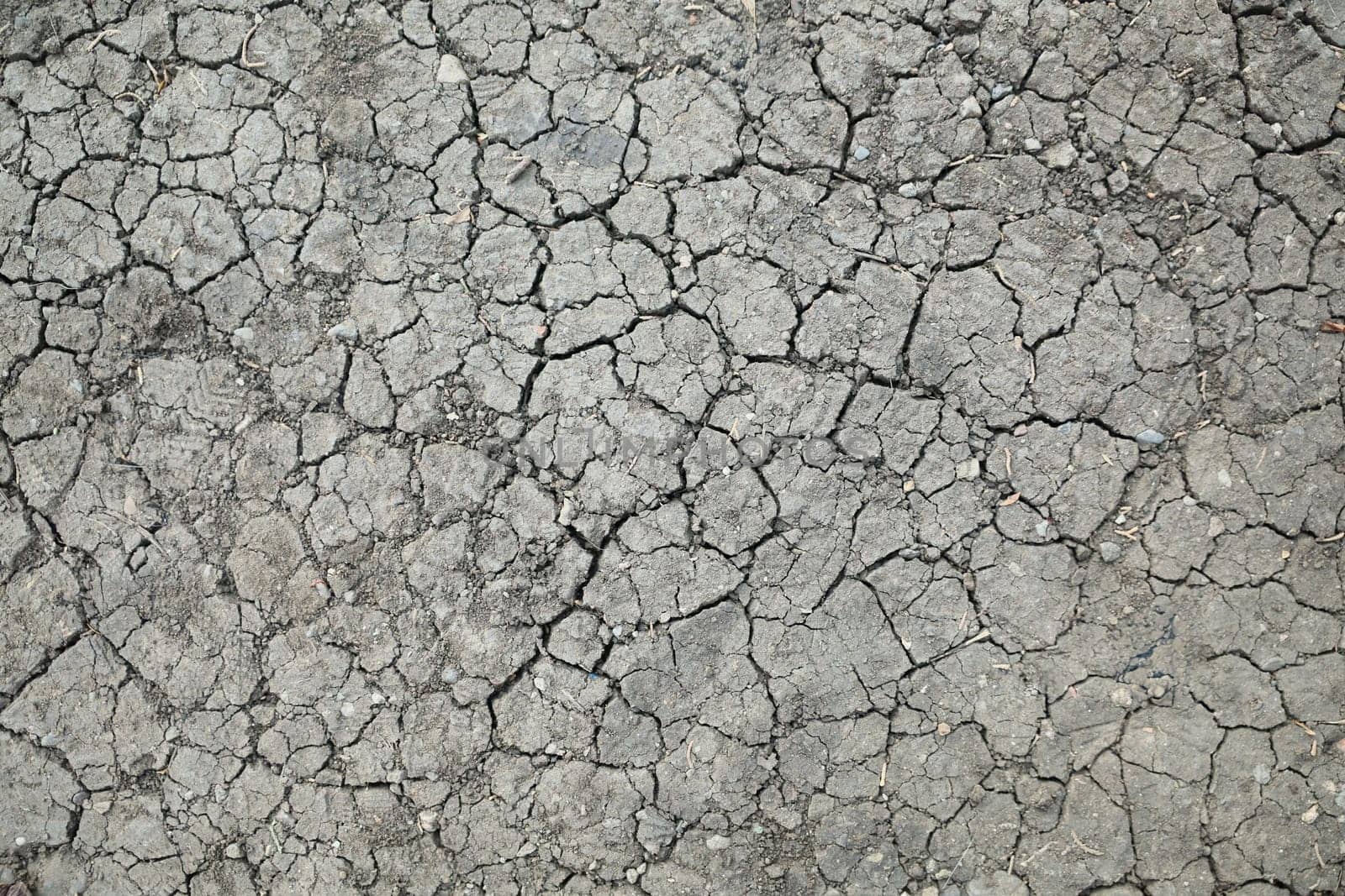 This is a closeup view of a dry, cracked surface that serves as an ideal background for design projects