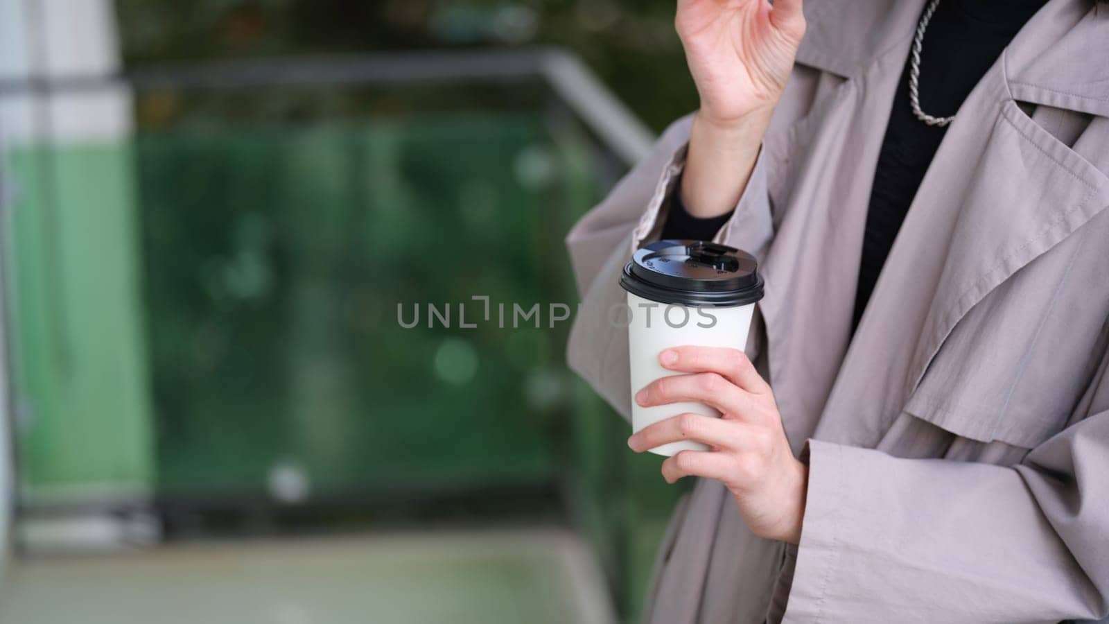A stylish adult indulging in a cup of coffee, exuding a sense of contemporary urban sophistication and elegance