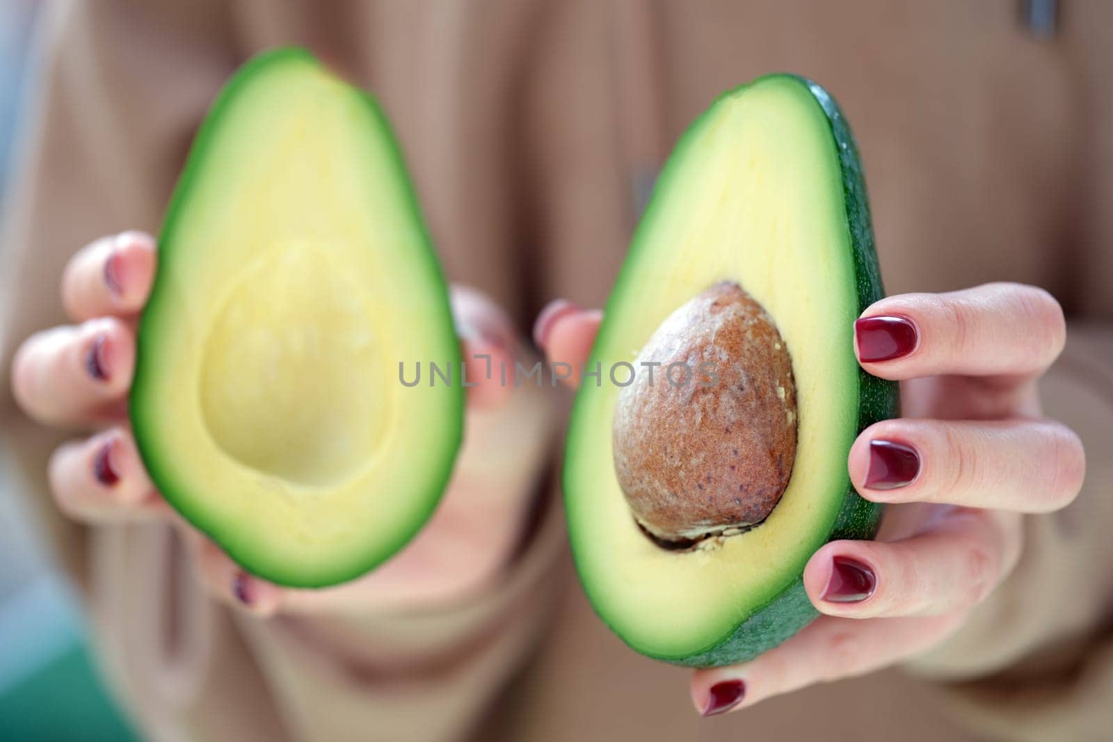 Beautifully cut avocado halves that showcase their creamy texture along with the seed at the center