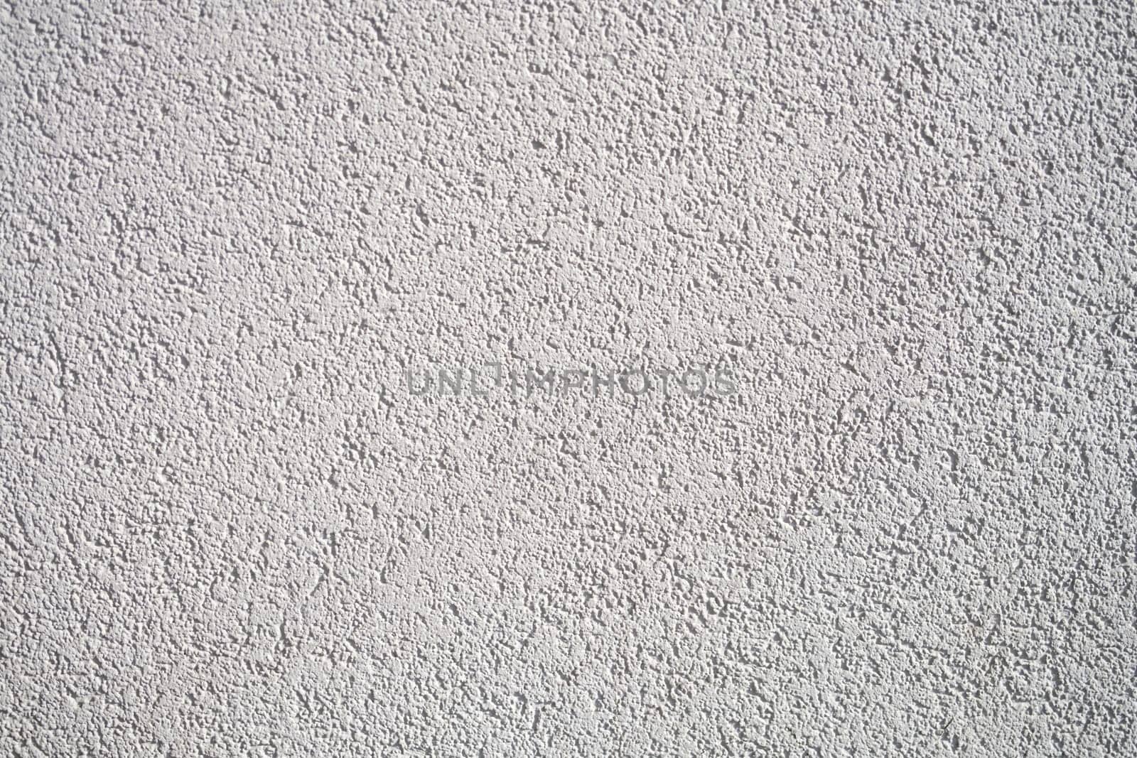 A detailed closeup of a light gray textured wall surface that beautifully showcases intricate patterns and designs
