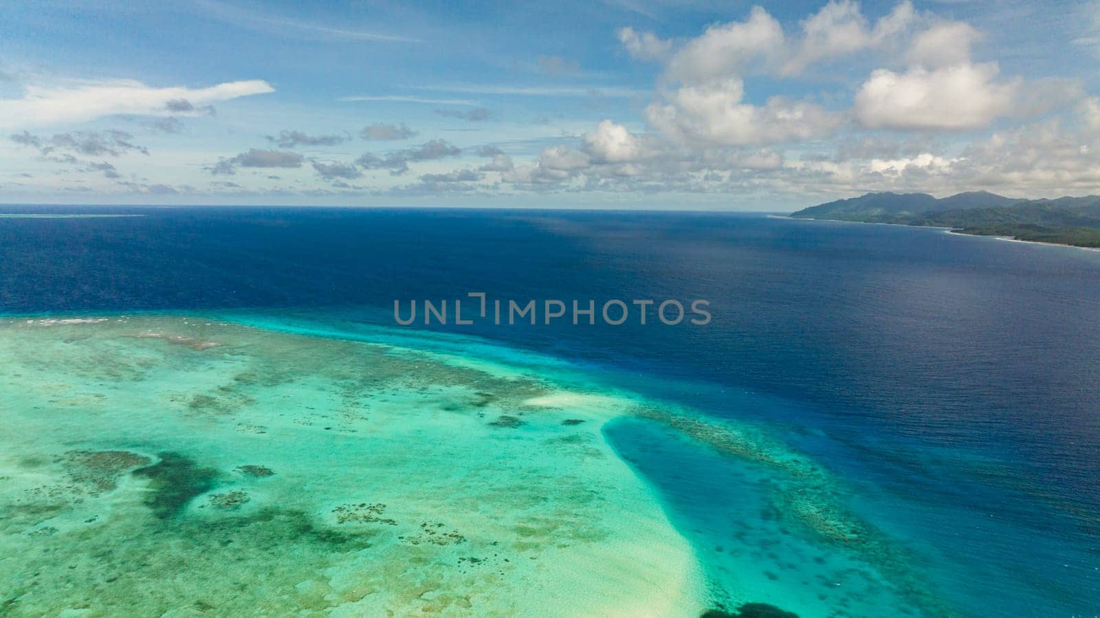 The coast of a tropical island covered with forest. Balabac, Palawan. Philippines.