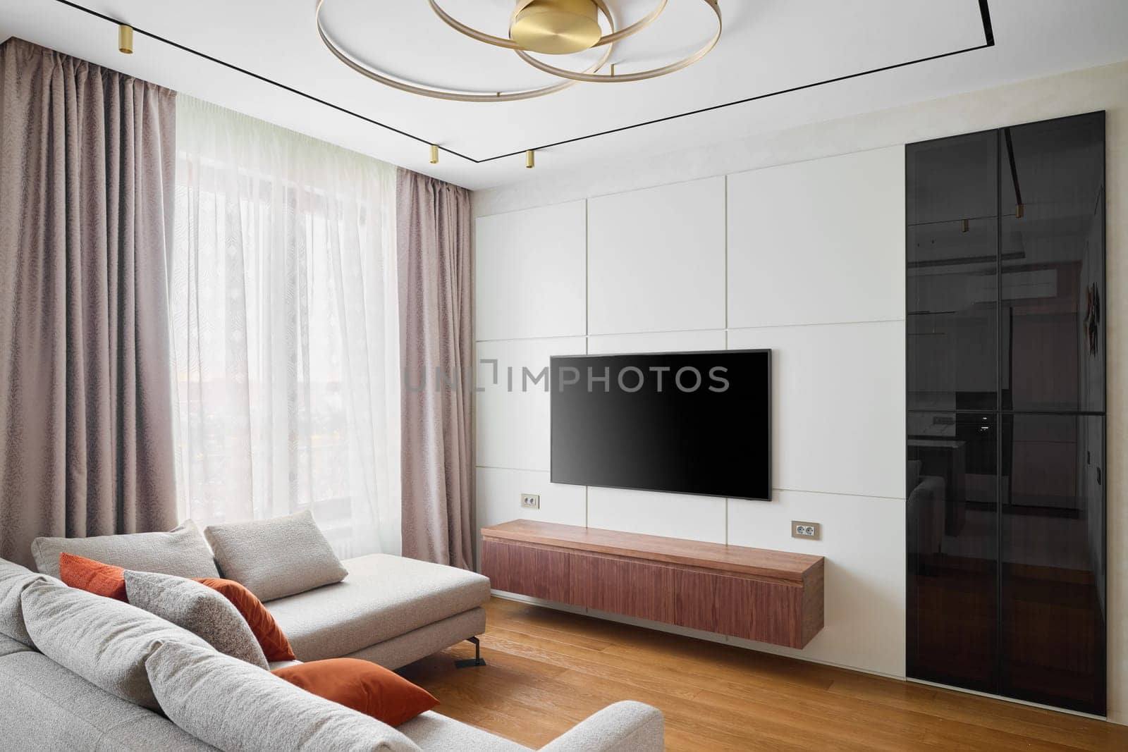 A sleek and modern living room that features minimalist decor, beautifully arranged furniture, and elegant accessories