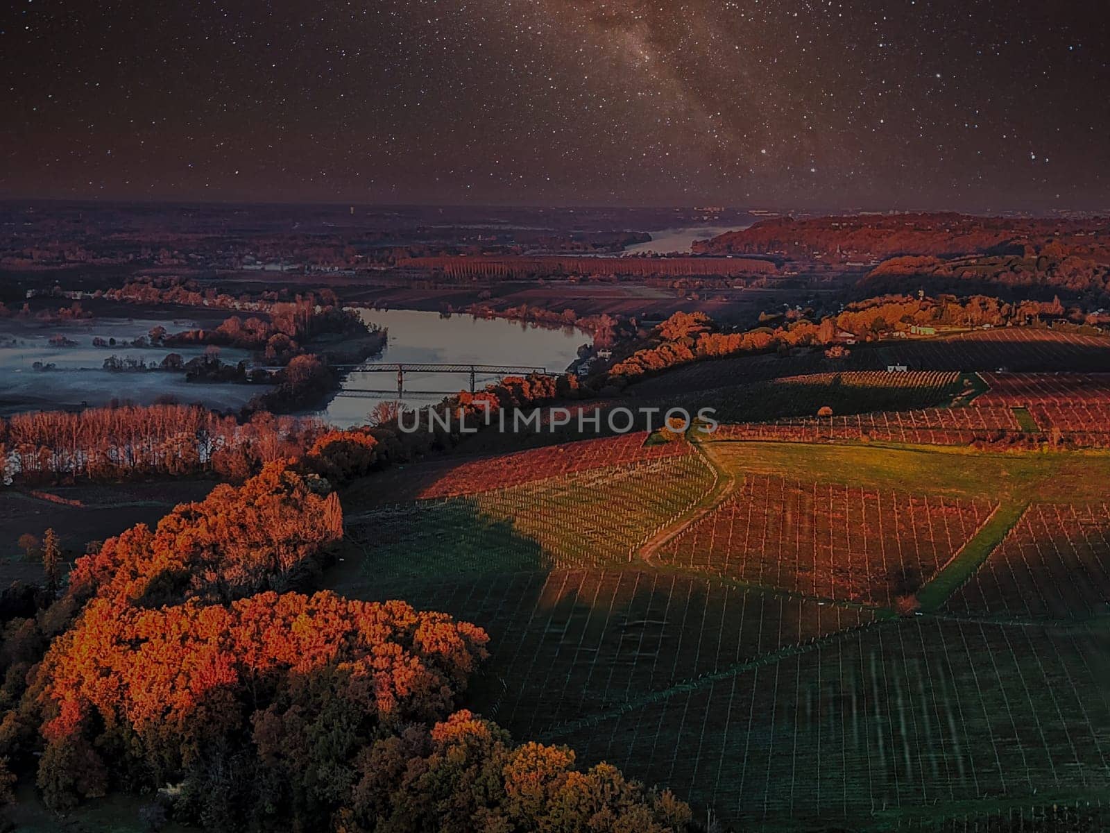 France, Gironde, Haut-Langoiran, Aerial view of the vineyard and wooded areas of Chateau de Langoiran in the Bordeaux vineyards at night. High quality photo