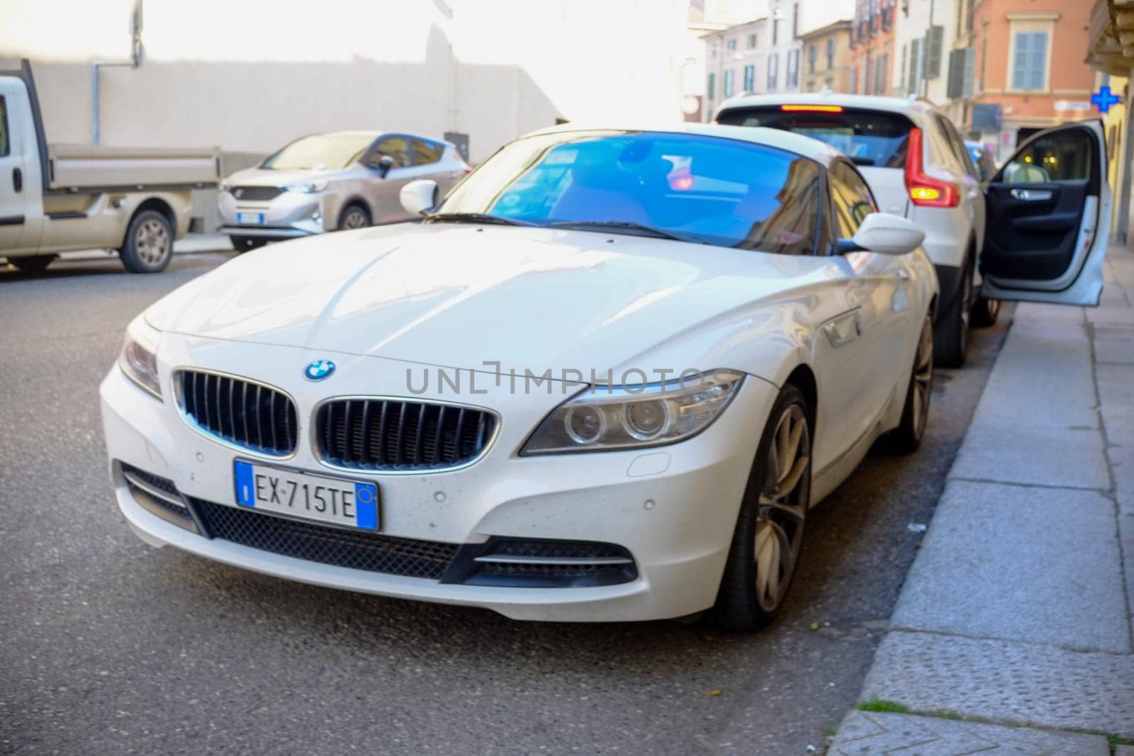 Cremona, Itally - October 6th 2024 A white bmw z4 sdrive28i roadster parked with the top down on a european city street, embodying elegance, style, and a sense of freedom
