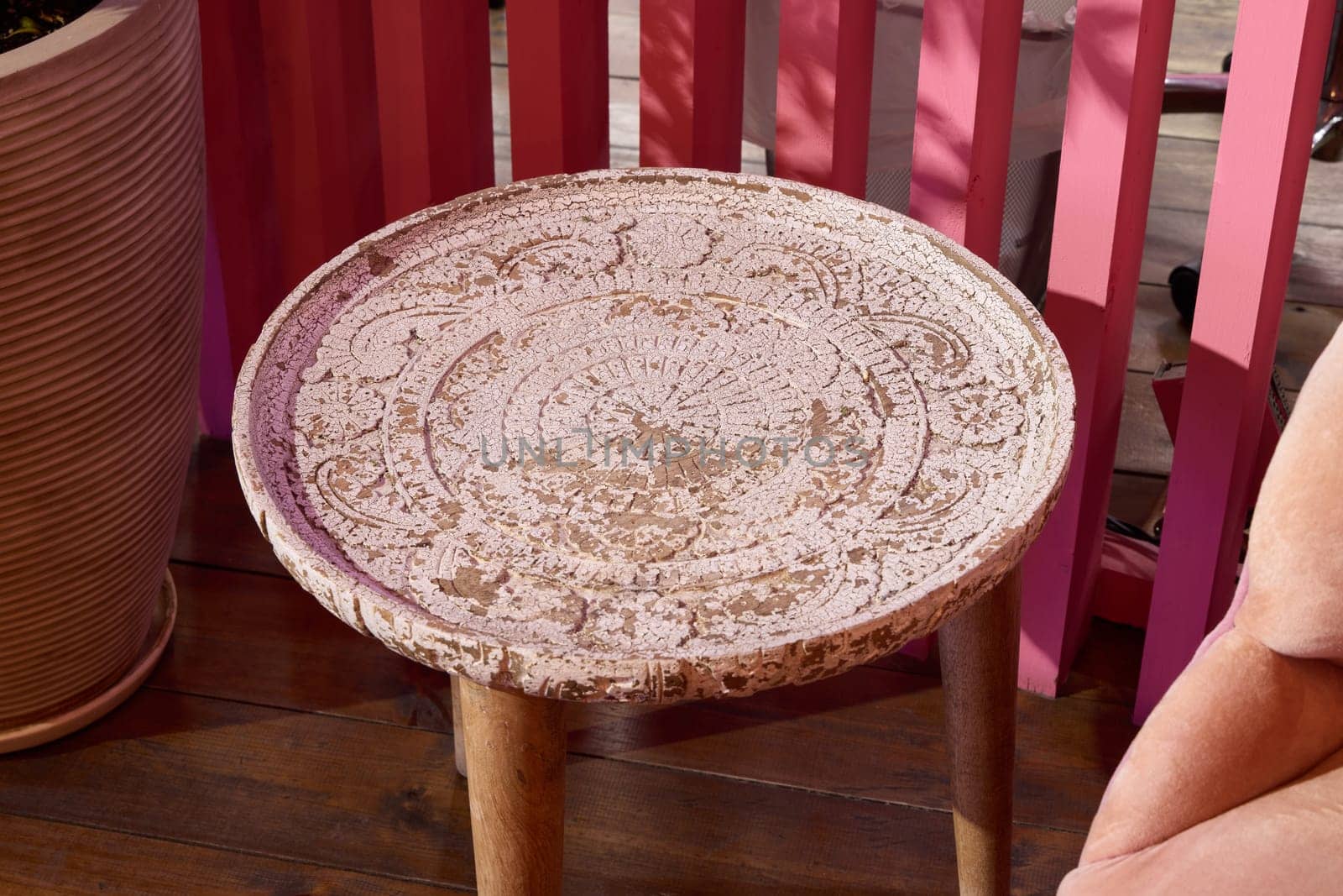 A charming round table that features very intricate designs along with rustic wooden legs for a cozy ambiance