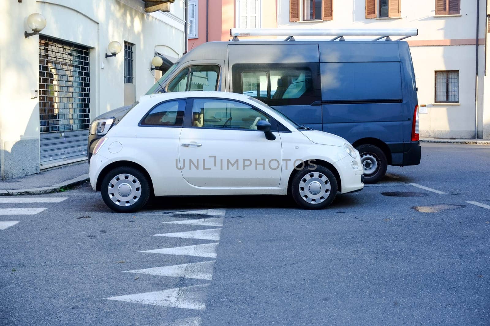 Cremona, Itally - October 6th 2024 Compact and modern white fiat 500 cult on display in an urban setting, highlighting its sleek design and small size