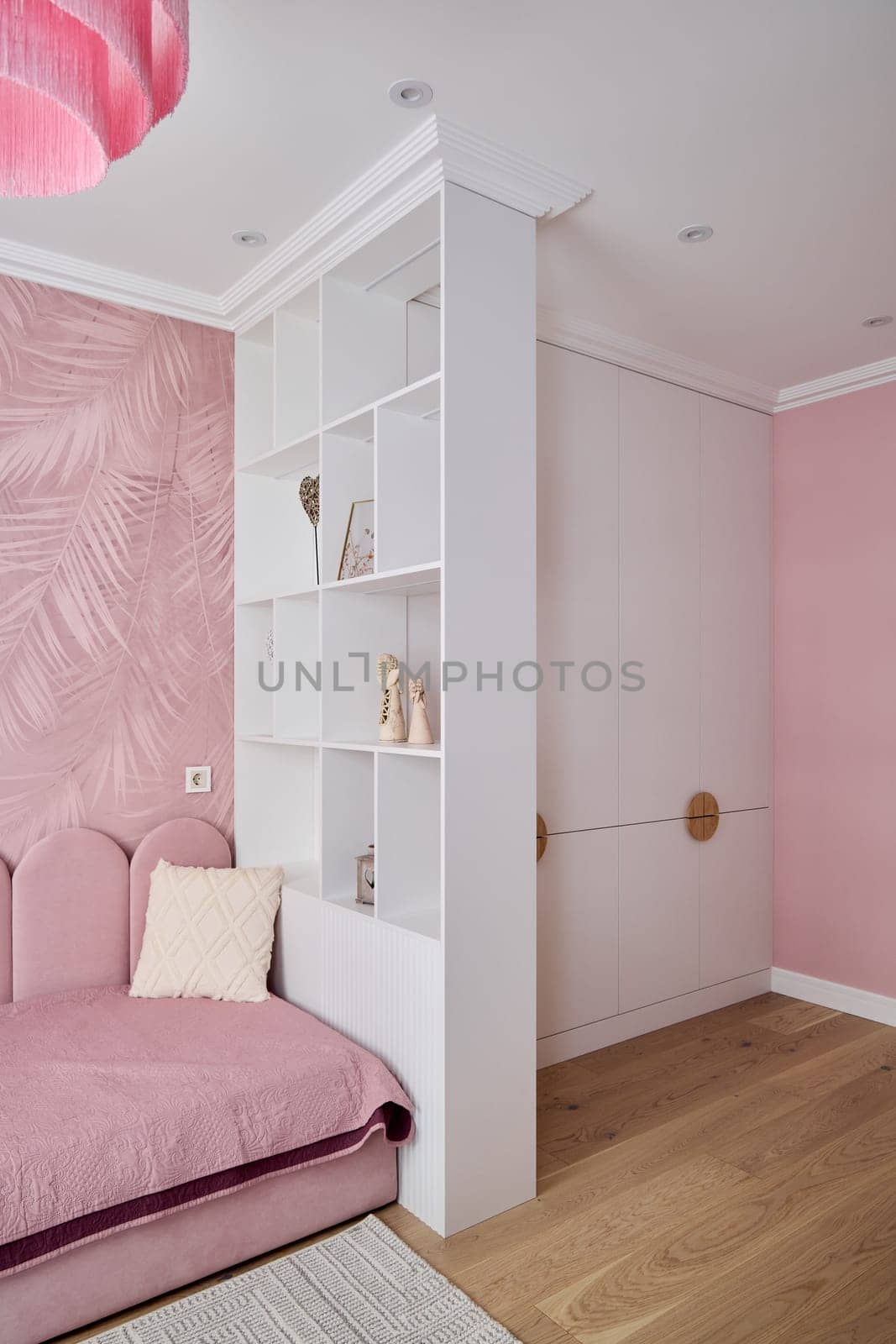 Stylish chic bedroom design that showcases beautiful pink tones, modern storage solutions, and trendy decor elements