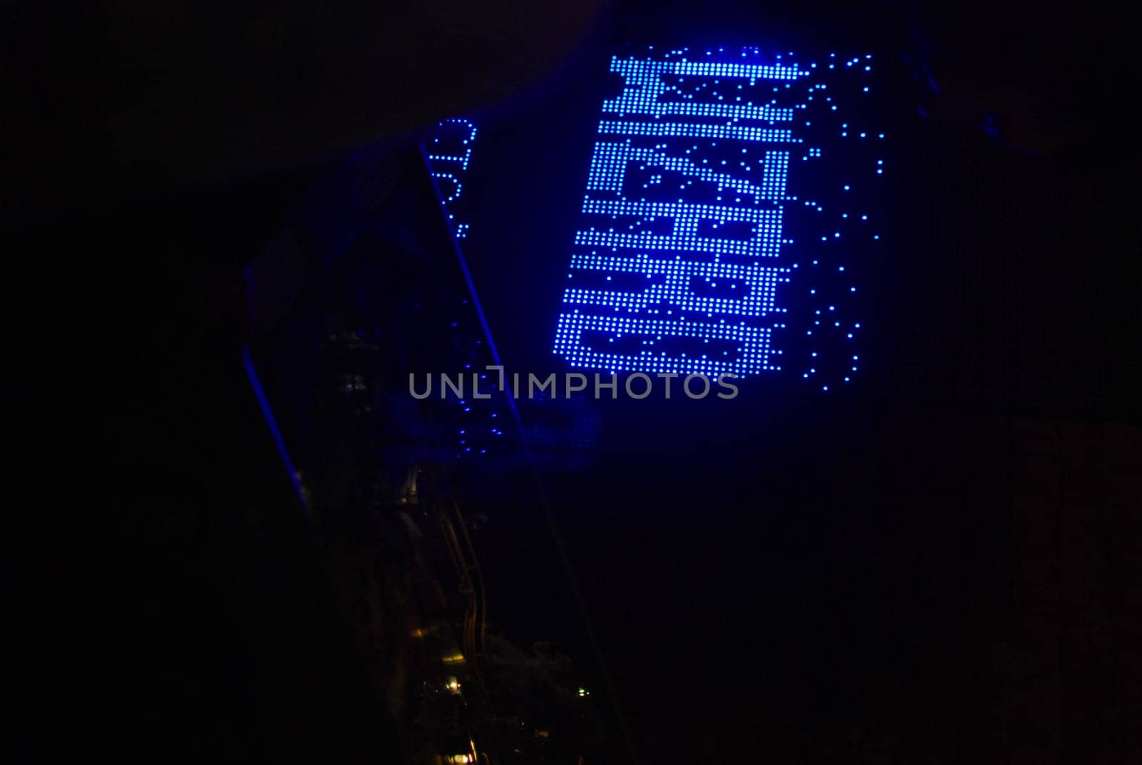 A vibrant blue sign shining brightly and reading WIZARD stands out beautifully at night, ideal for magical themes
