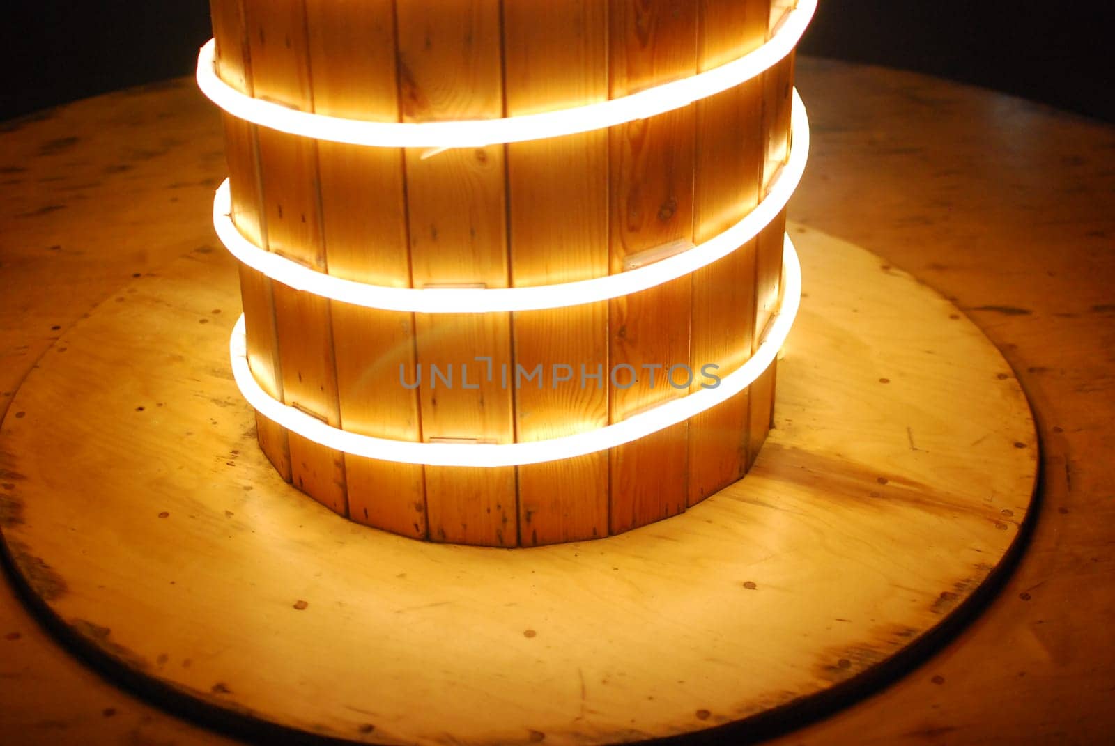 A wonderfully captivating wooden column is beautifully illuminated by glowing circular lights, creating a warm ambiance