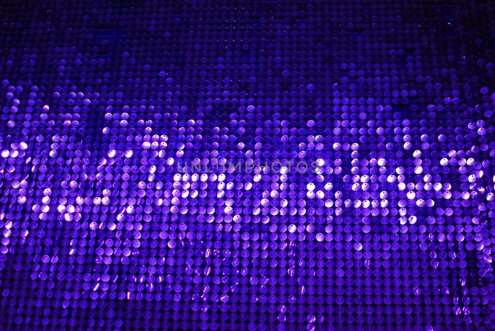 A dazzling and shimmering purple sequin backdrop that is perfect for various designs, events, and creative projects