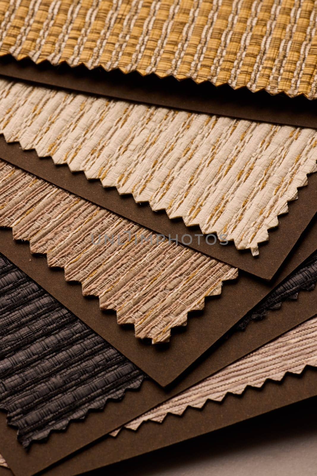 This is a collection of beautiful fabric samples showcasing rich textures and warm colors for interior design