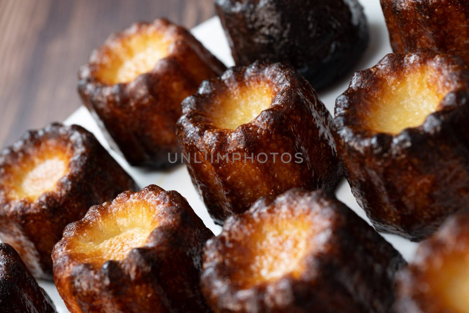Caneles de bordeaux, traditional French sweet dessert with white table background, High quality photo