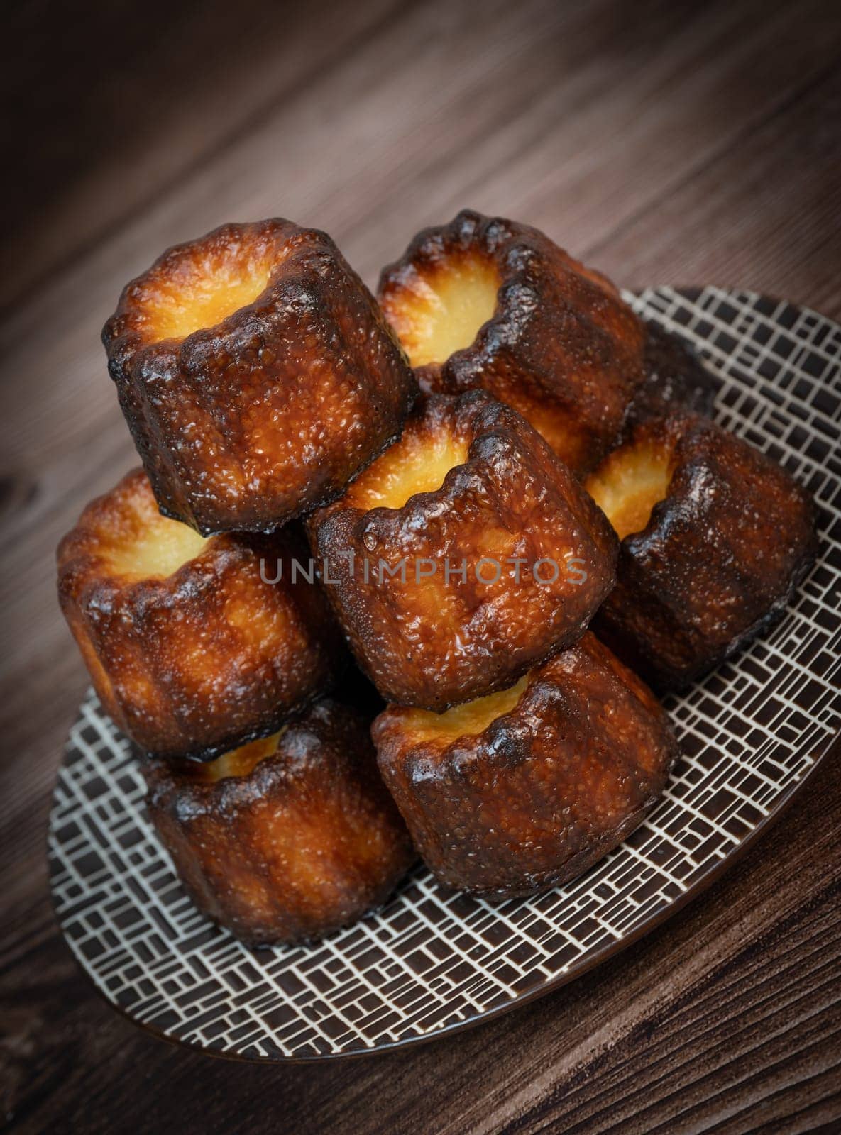 Caneles de bordeaux, traditional French sweet dessert with white table background, High quality photo