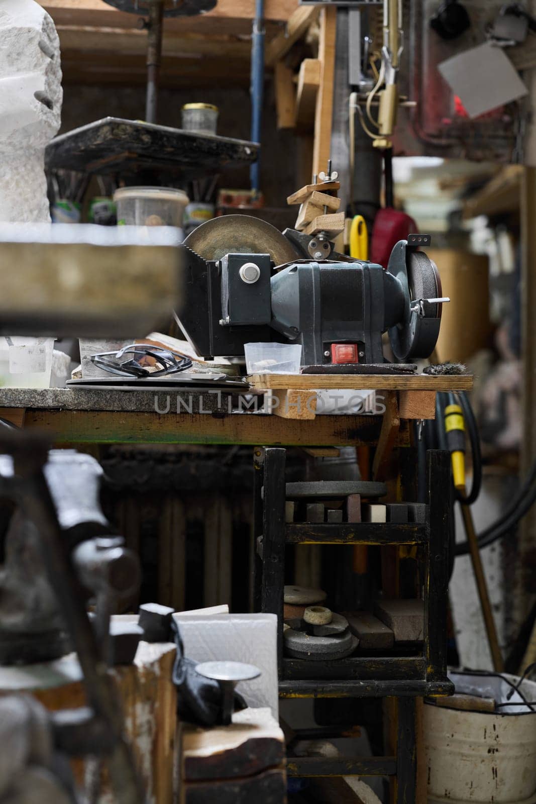 A cluttered workspace that showcases an array of tools and equipment designed for various crafting projects