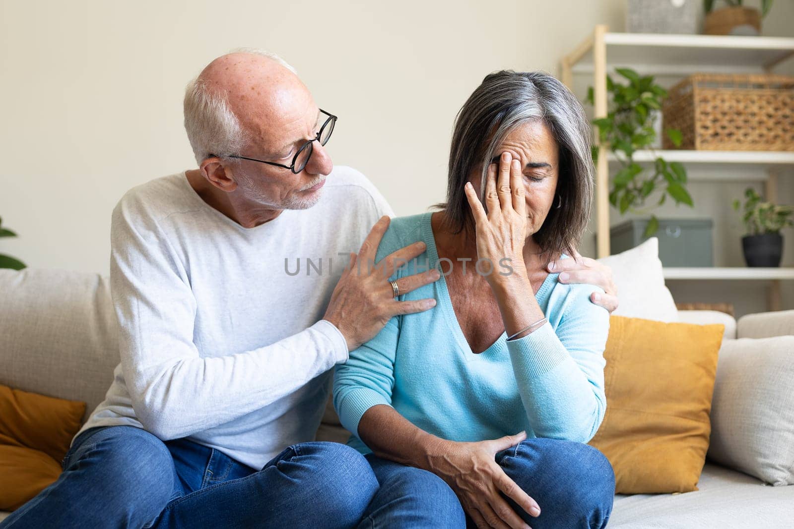 Mature man consoling depressed wife at home. Mature married couple have relationship problems. Mental health concept.