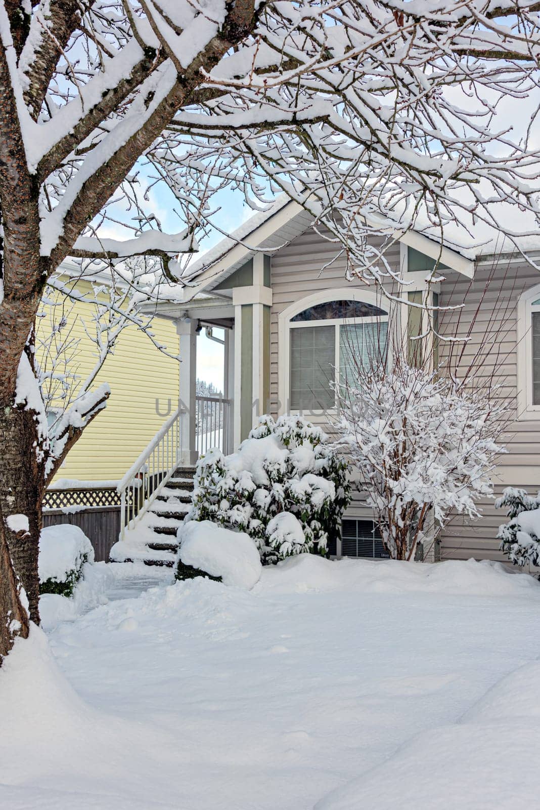 Residential house window on bright winter day. Nice residential house in snow.